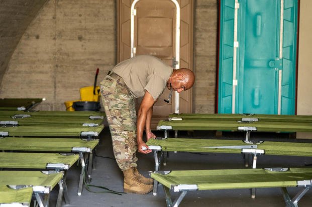 A U.S. soldier assigned to Joint Task Force Southern Guard, aligns cots in the hardened shelter in preparation for hurricane Melissa on at Naval Station Guantanamo Bay, Cuba, Oct. 24, 2025 (U.S. Air Force photo By Senior Airman Taylor Hunter)