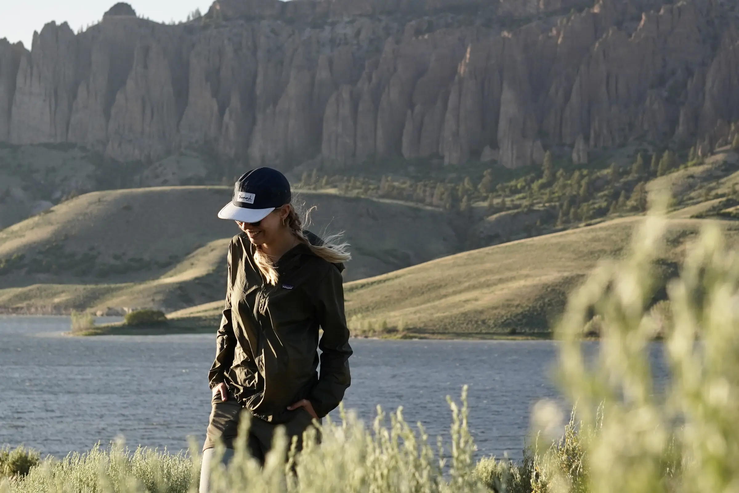 Wearing the Patagonia Houdini windbreaker jacket near a windy lake