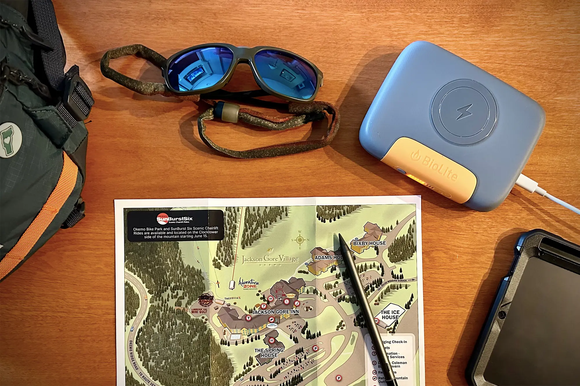 BioLiite Charge 100 Max next to map glasses backpack