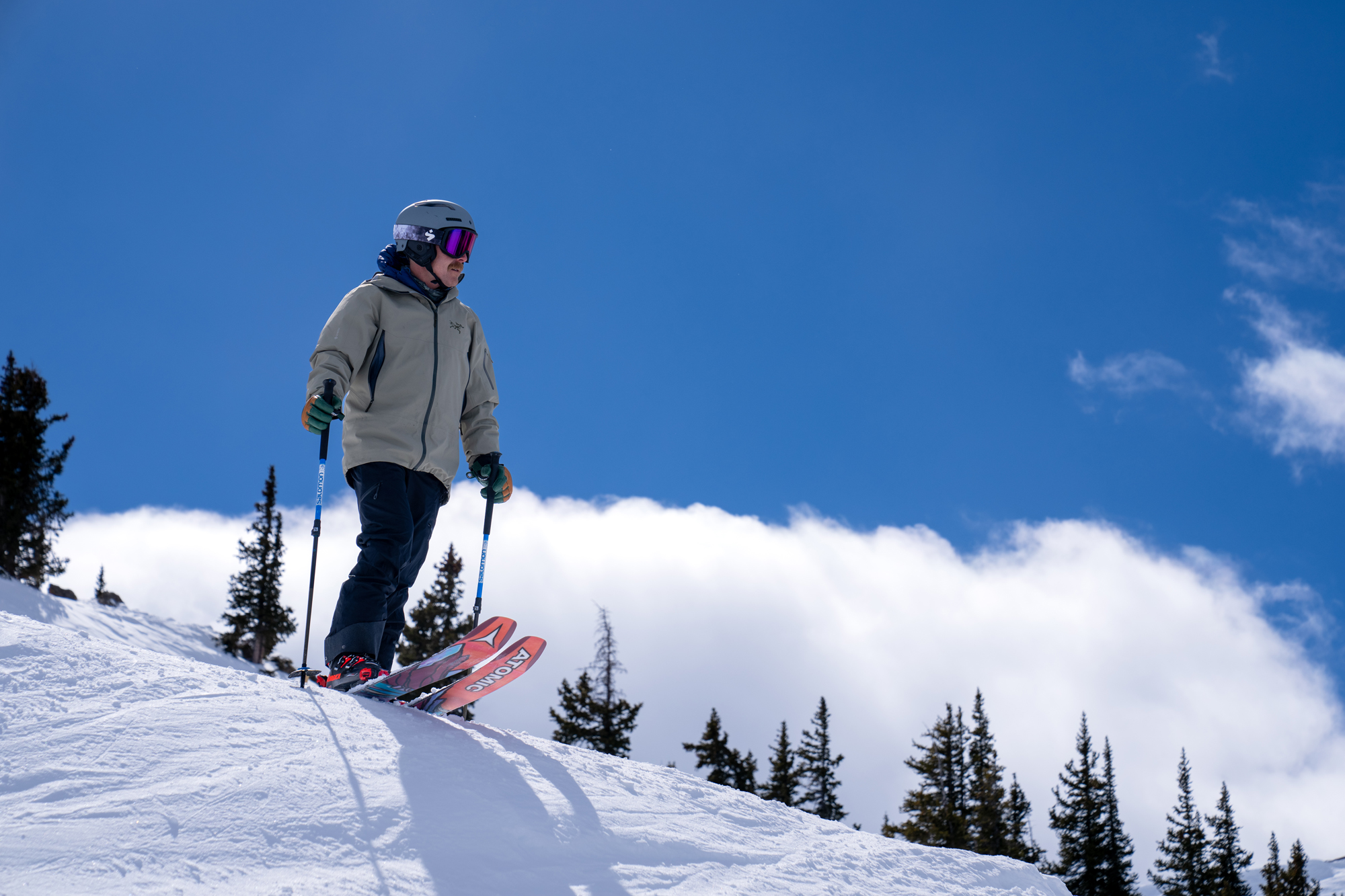 All-mountain skier stands at the top of a ski run