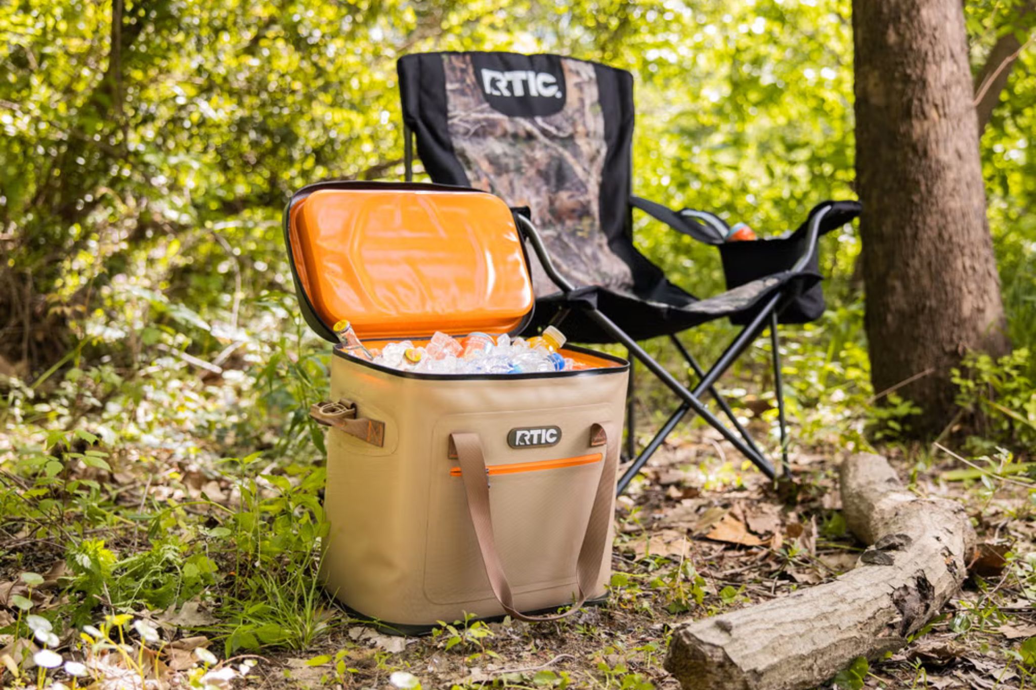 Tan cooler filled with ice set up outside next to camping chair