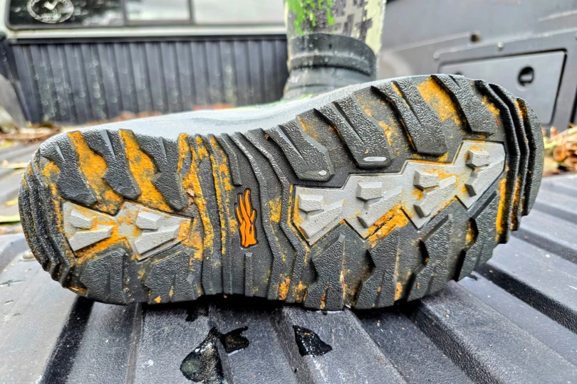 The bottom tread of the Sitka Back40 Boot shows mud and wear after outdoor use