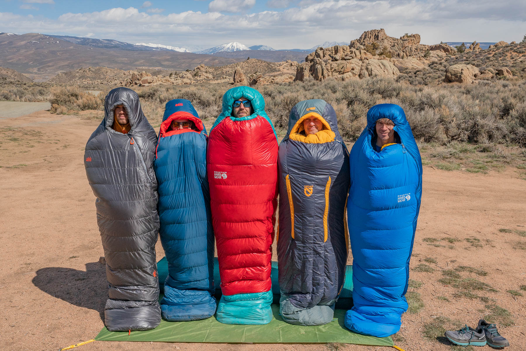 five people standing in sleeping bags in colorado