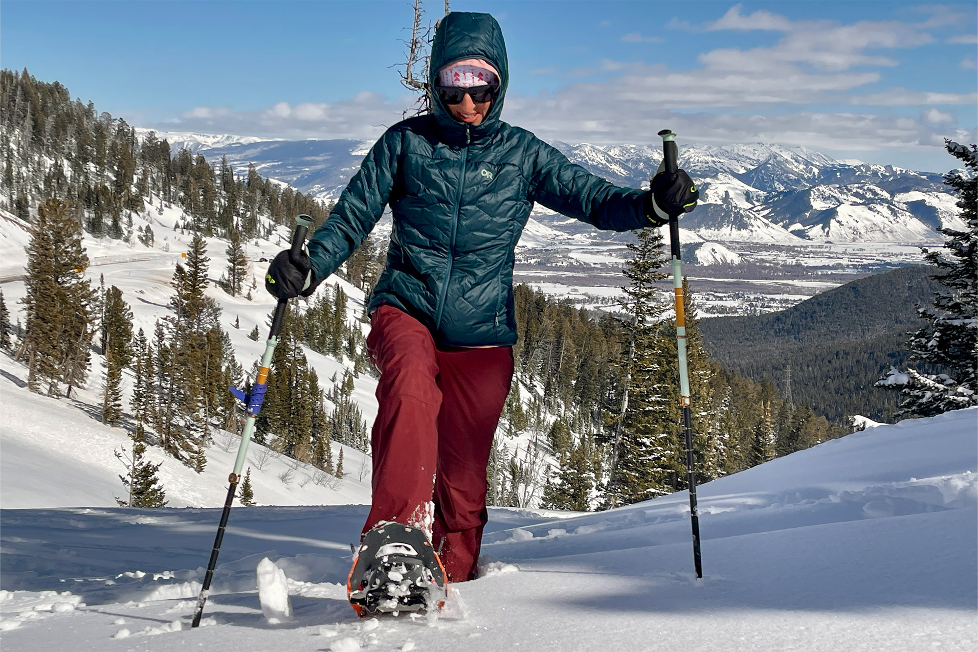 Snowshoer climbing a snowy slope in the mountains