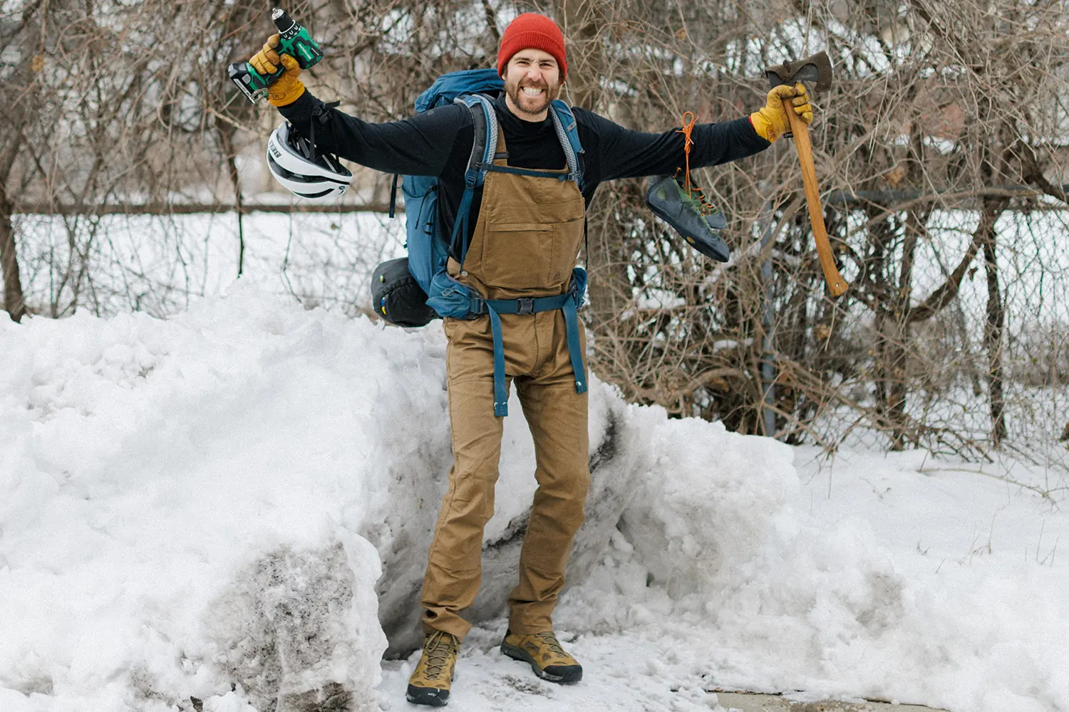 man wearing overalls with tools and gear