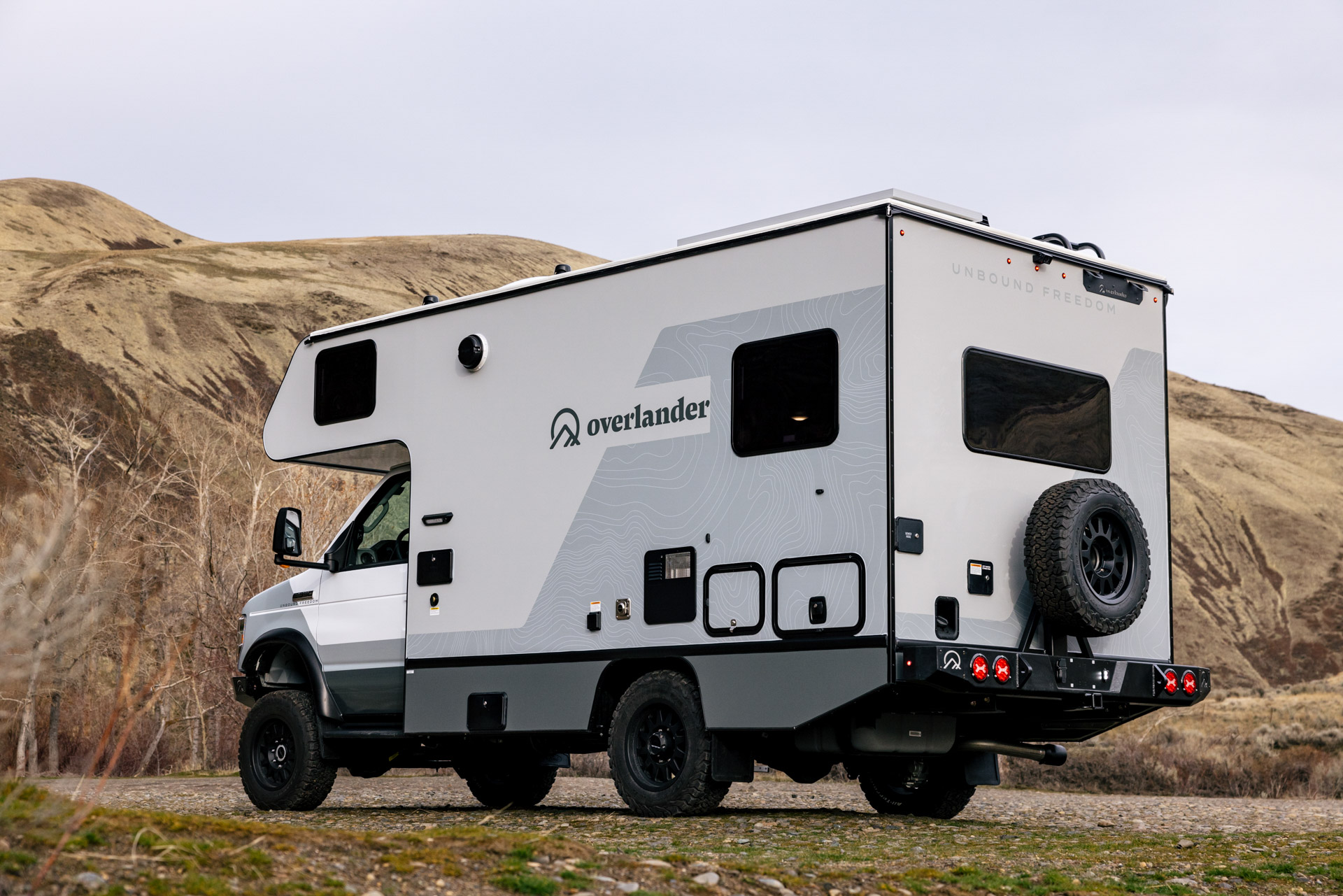 the rear quarter aspect of the ridge xt truck in a grassland 