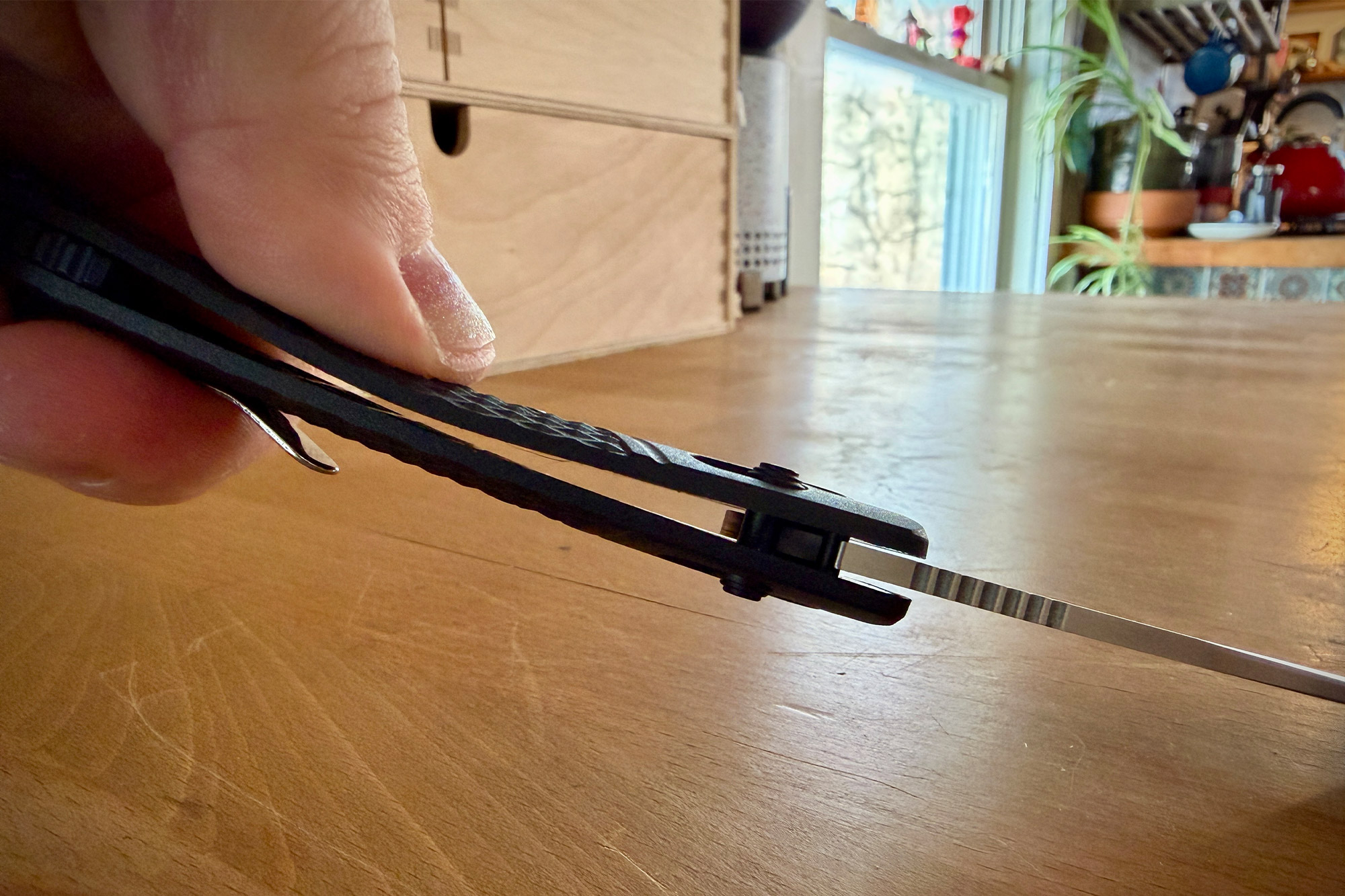 The Counterpart knife shown from the side with the blade partially open and the liner lock visible