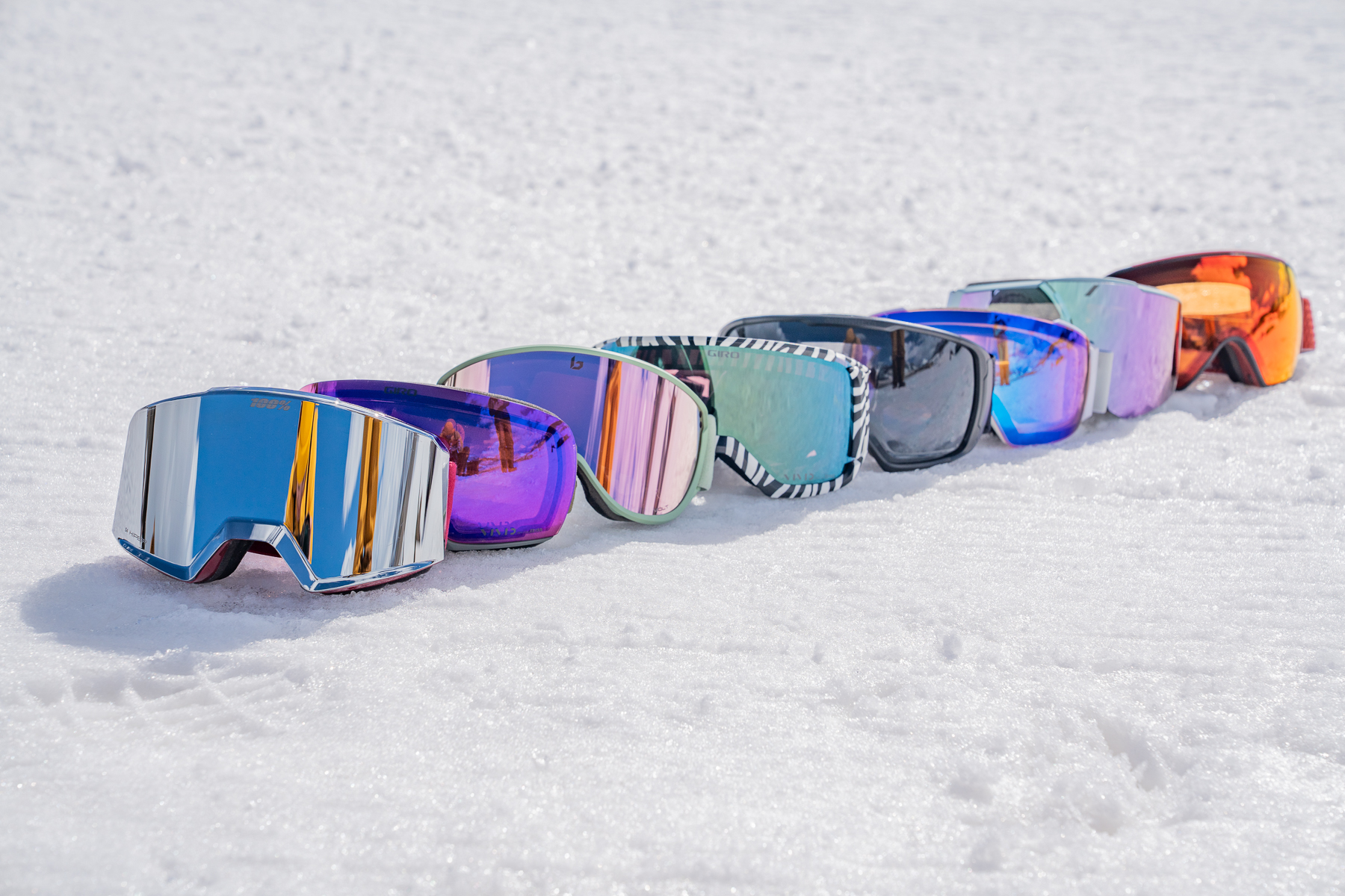 a lineup of snow goggles on the snow