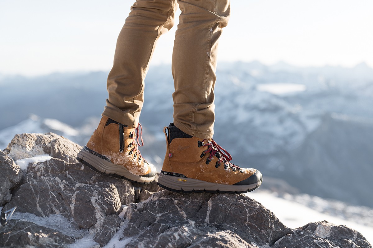 model standing on rock wearing canvas pants and Danner Arctic 600 Best Boots