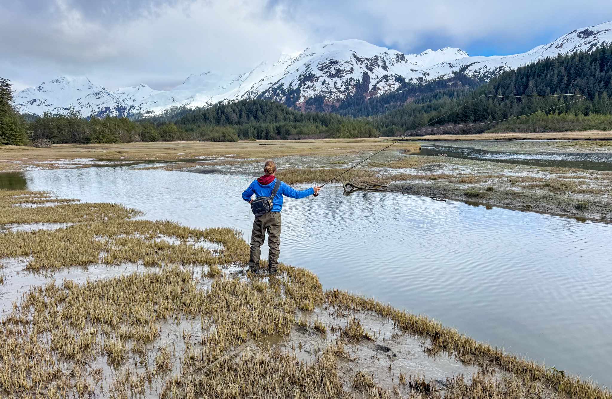 Patagonia Swiftcurrent Traverse Waders during fly casting in a muddy marsh near a stream