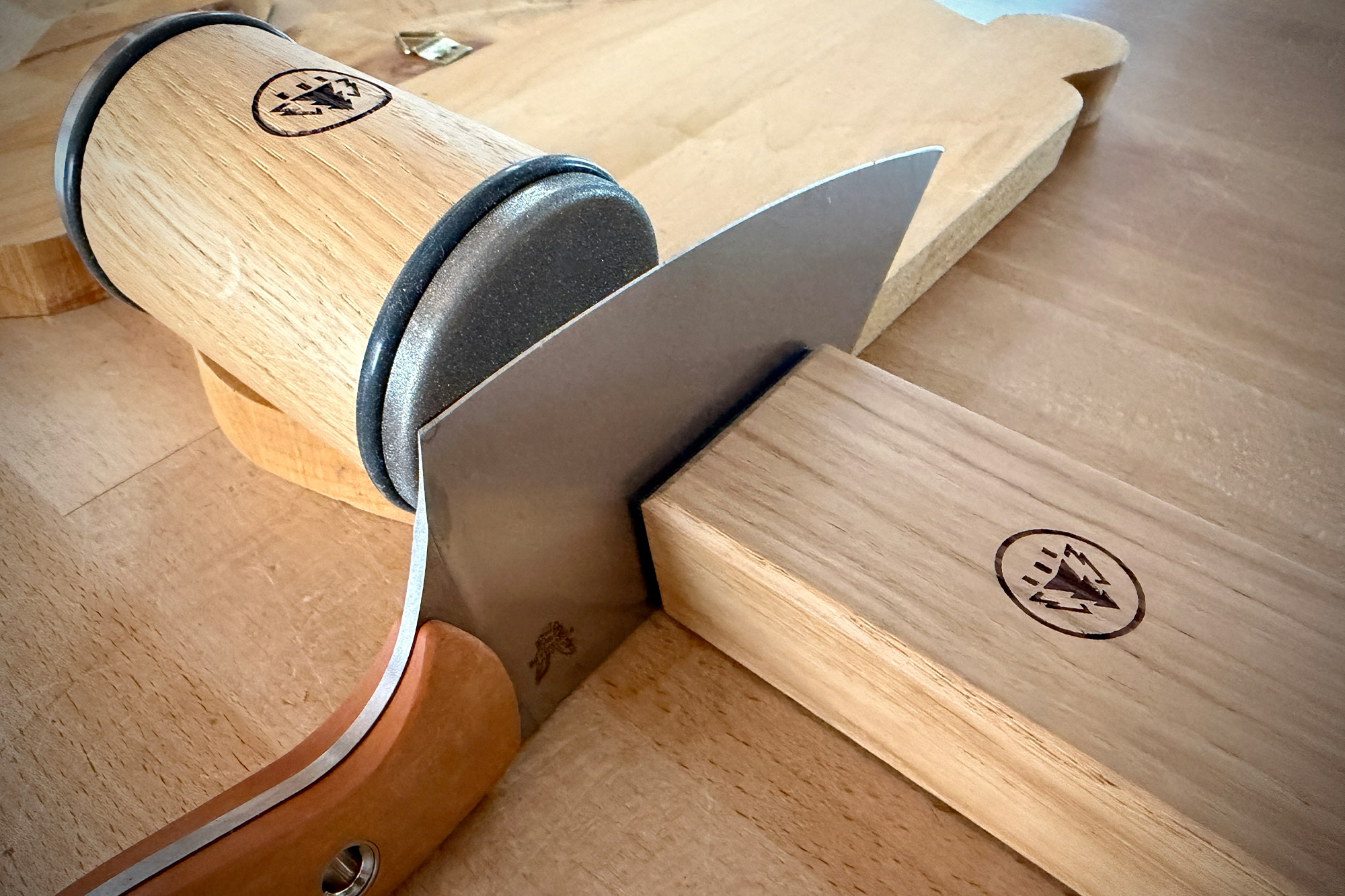 The HORL sharpener rolls along a knife blade while the blade rests against the angle block