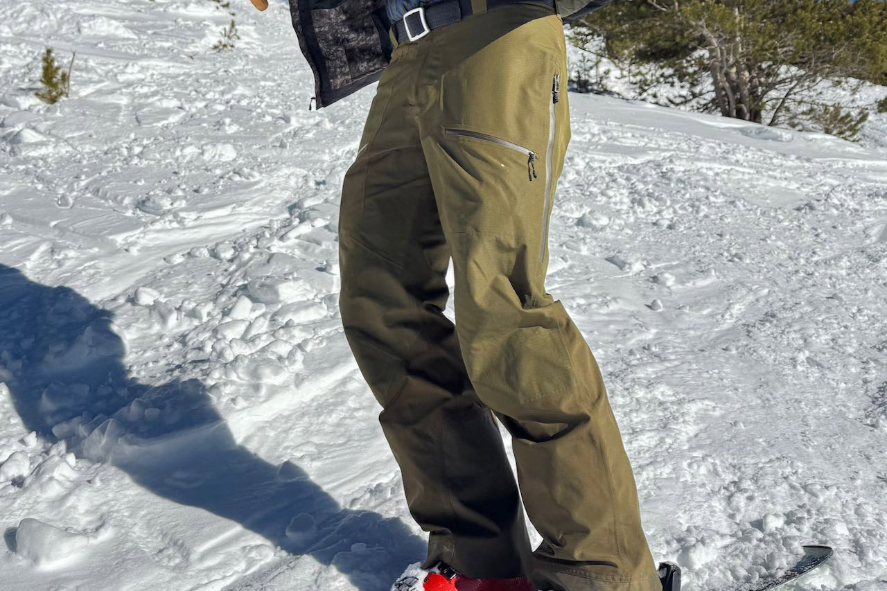 Powderverse ski pants shown from the side while standing on snow