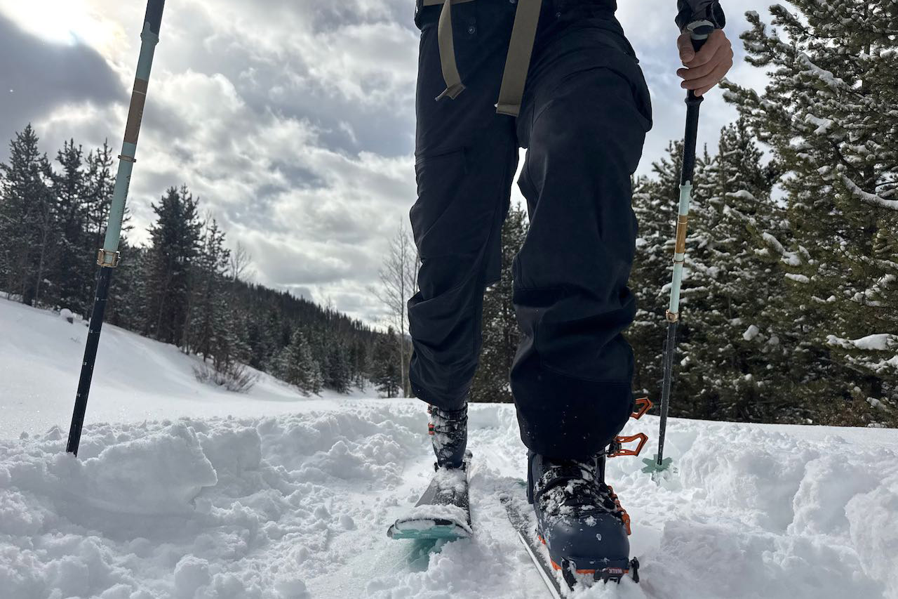 Skier walking uphill on skis wearing Scarpa 4-Quattro GT boot 