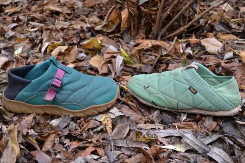 two teva slipper shoes next to each other in leaves