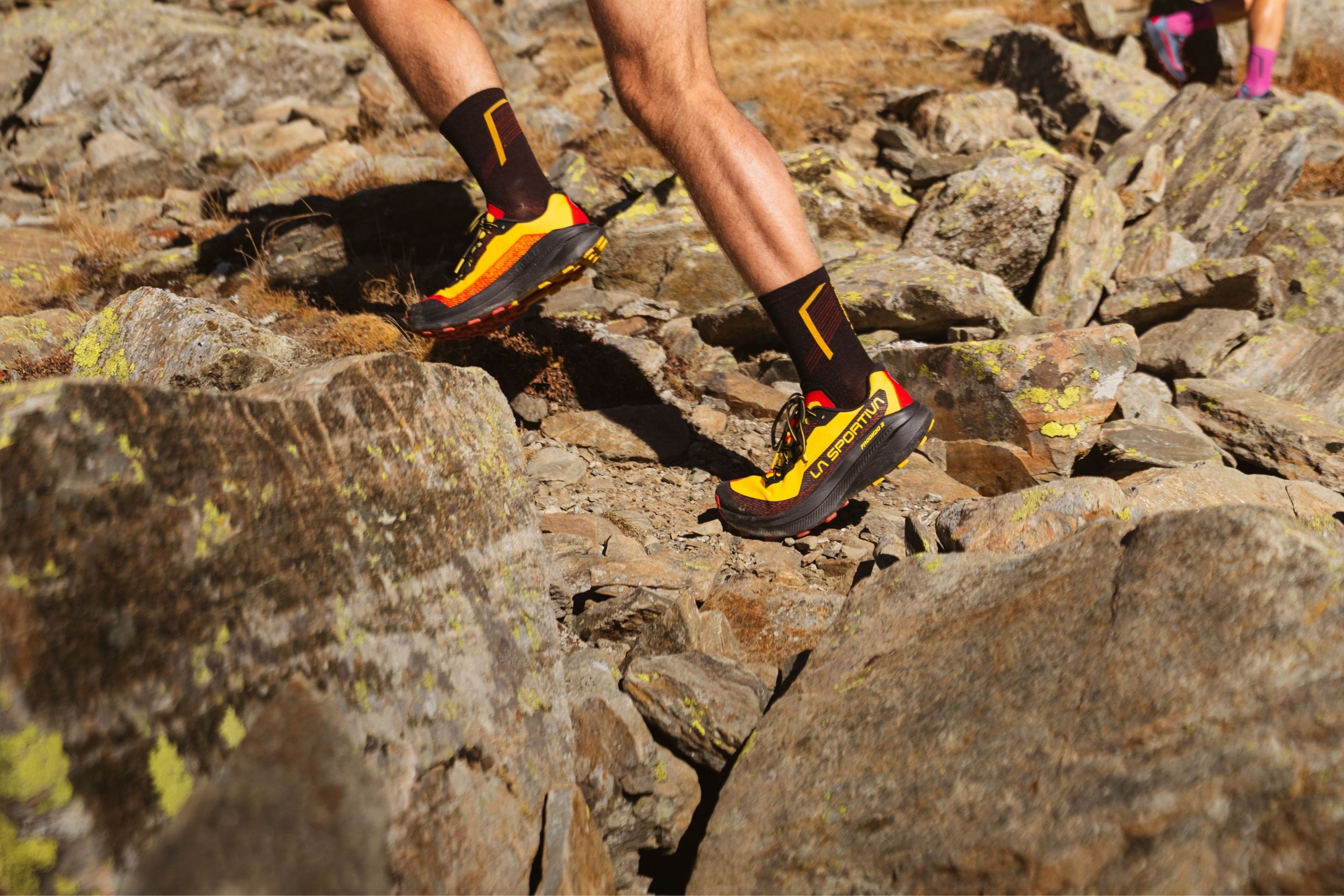 close-up shot of person running on rocky terrain outside