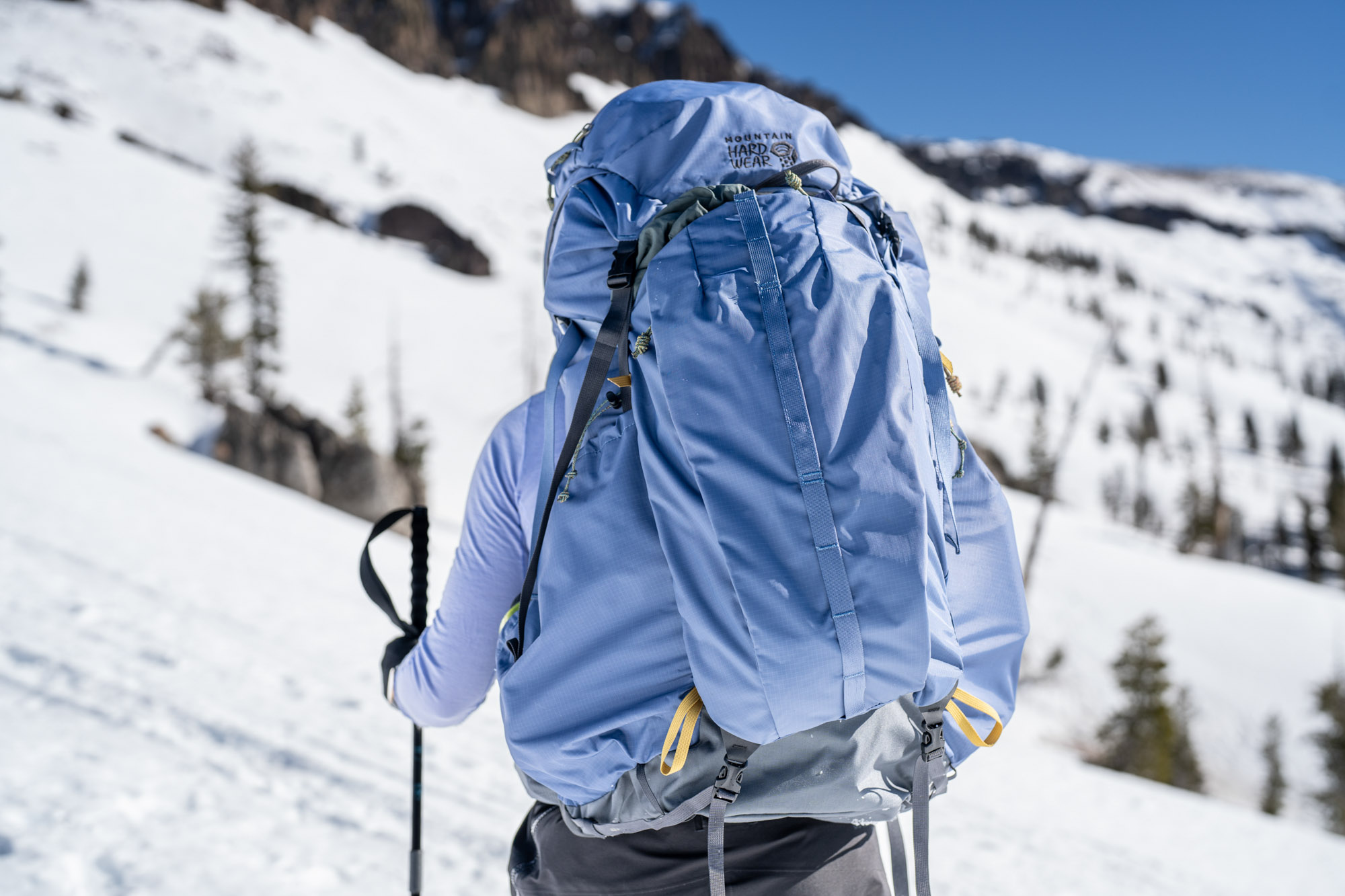 a ski tourer uses the mountain hardware pct backpacking pack in spring