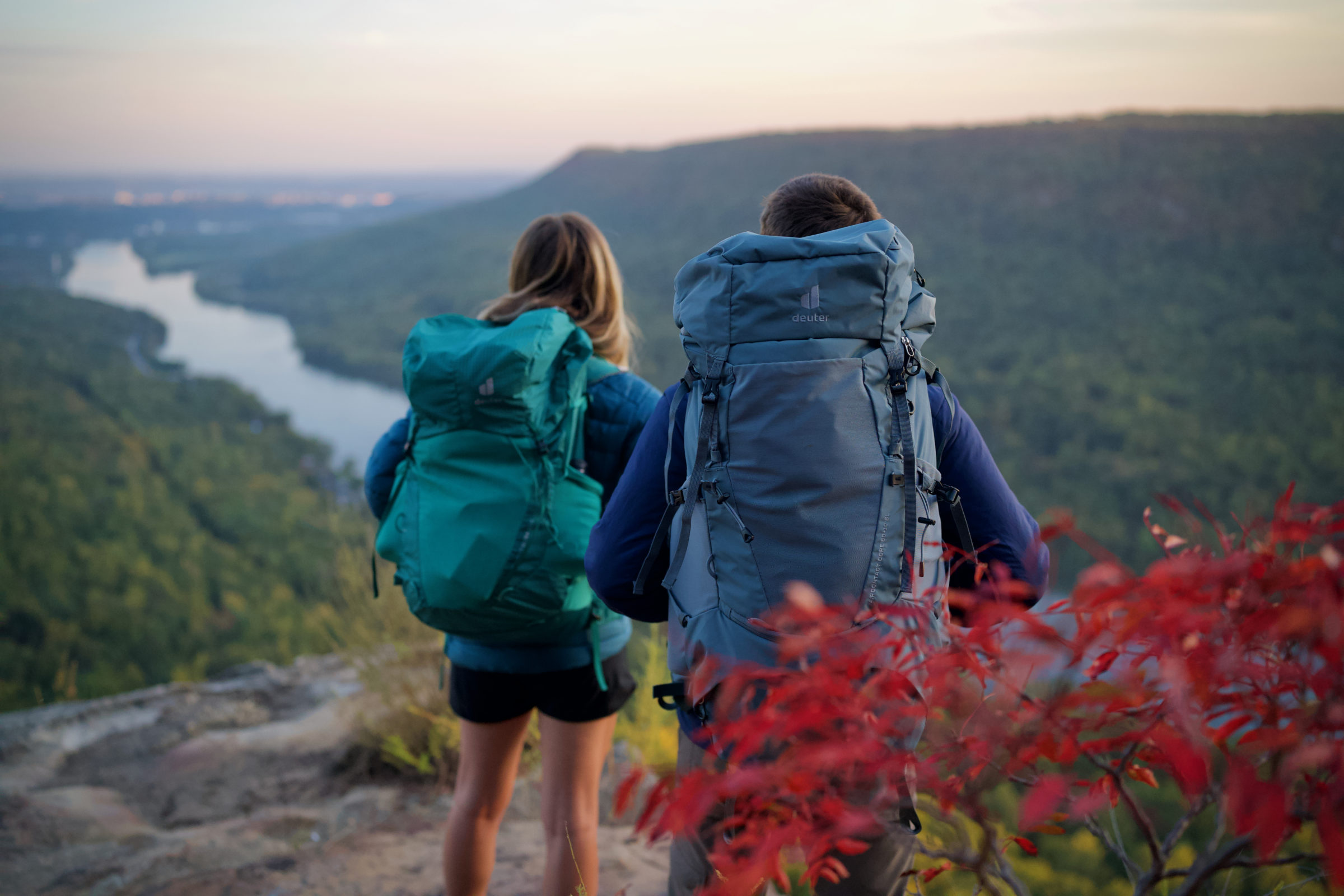 two hikers wearing deuter backpacking packs overlook a scene in the southeast