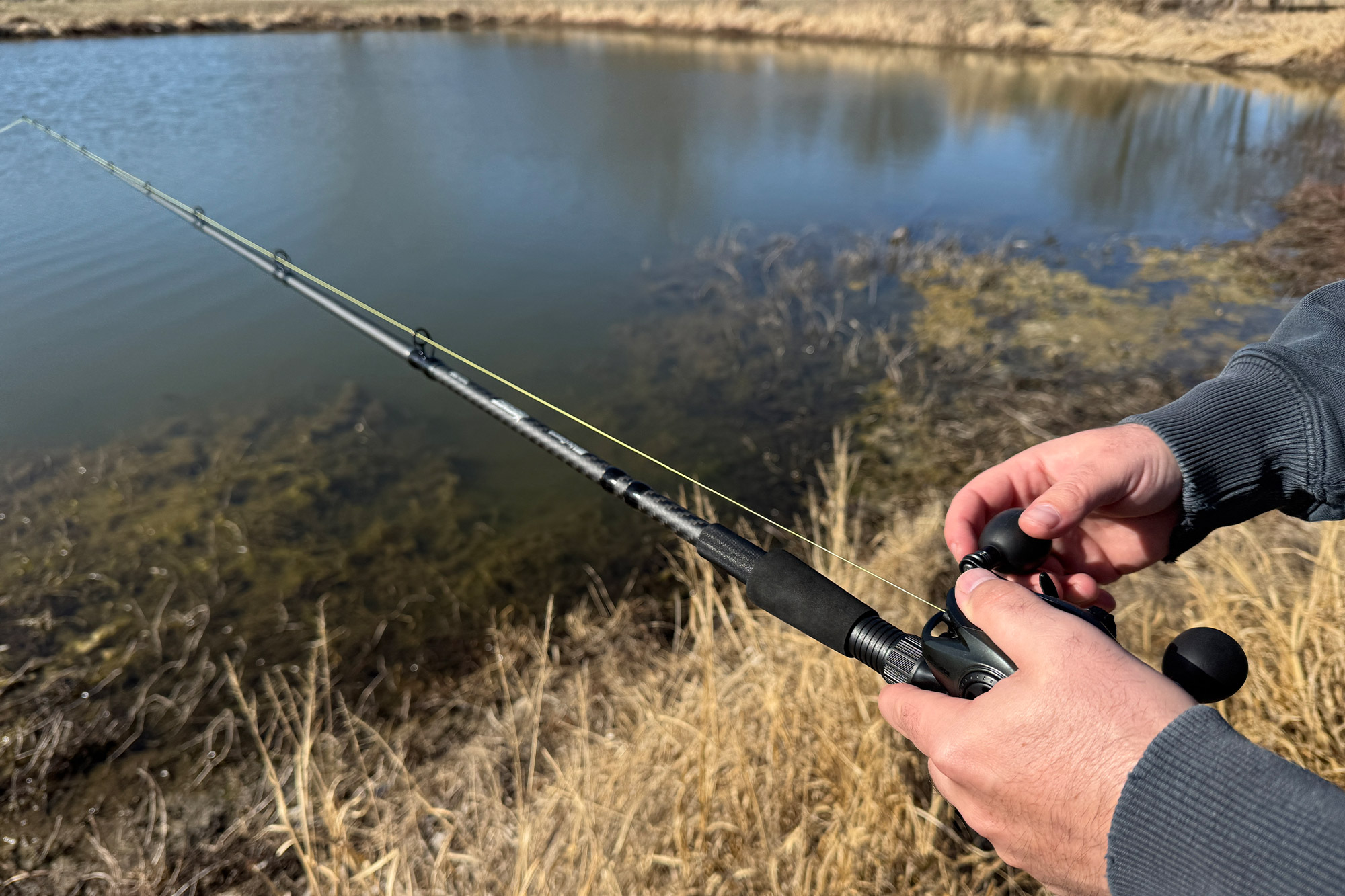 The Abu Garcia Beast combo is cast along the edge of a grassy pond