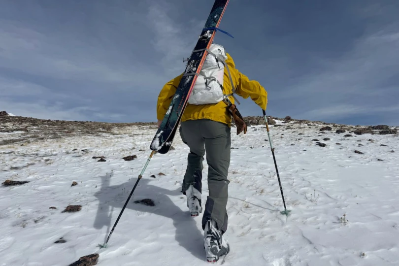 The Arc’teryx Alpha SL pack carried during a backcountry climb with skis attached