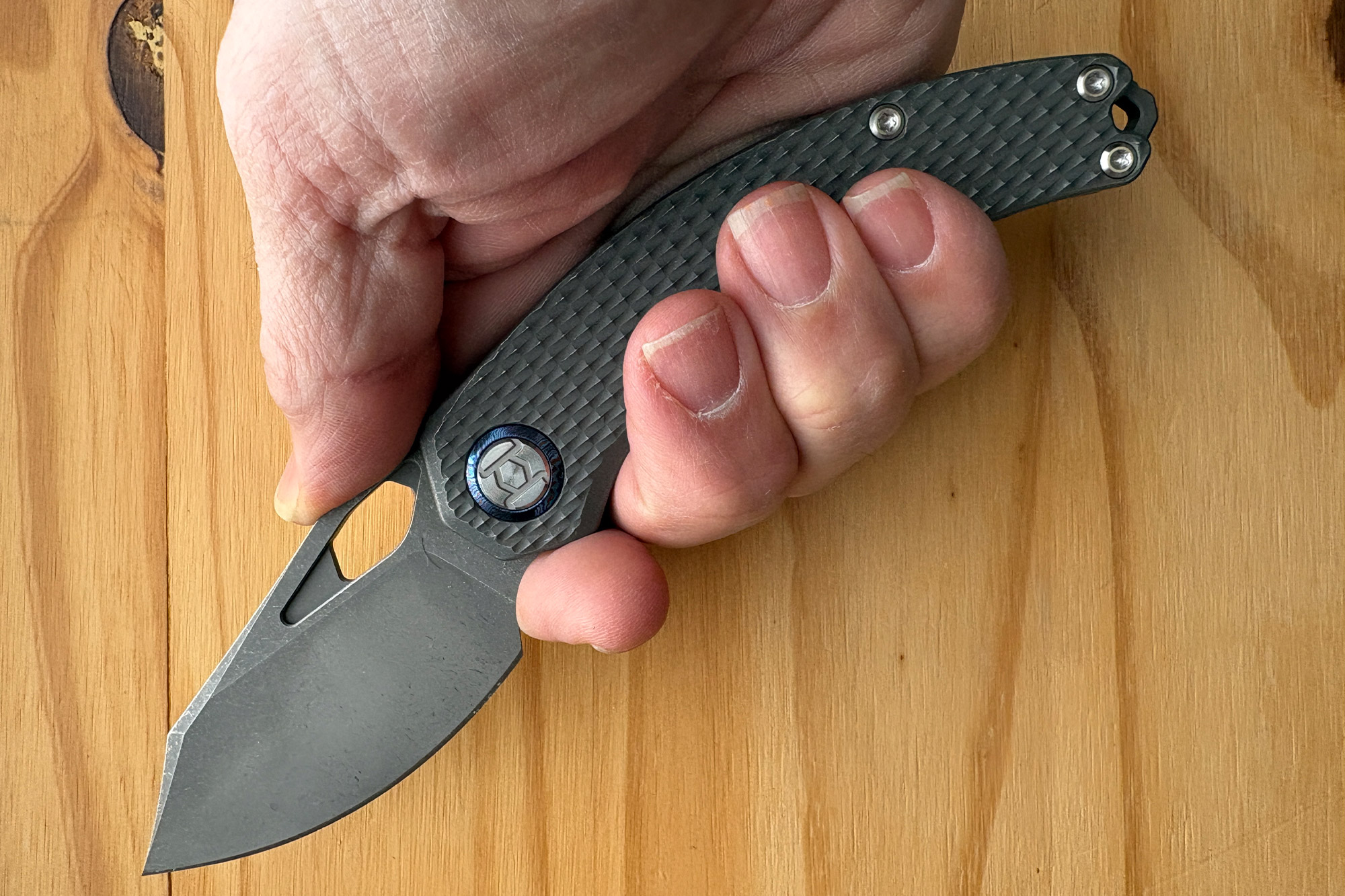 Open Compadre knife held in hand to show grip and blade shape