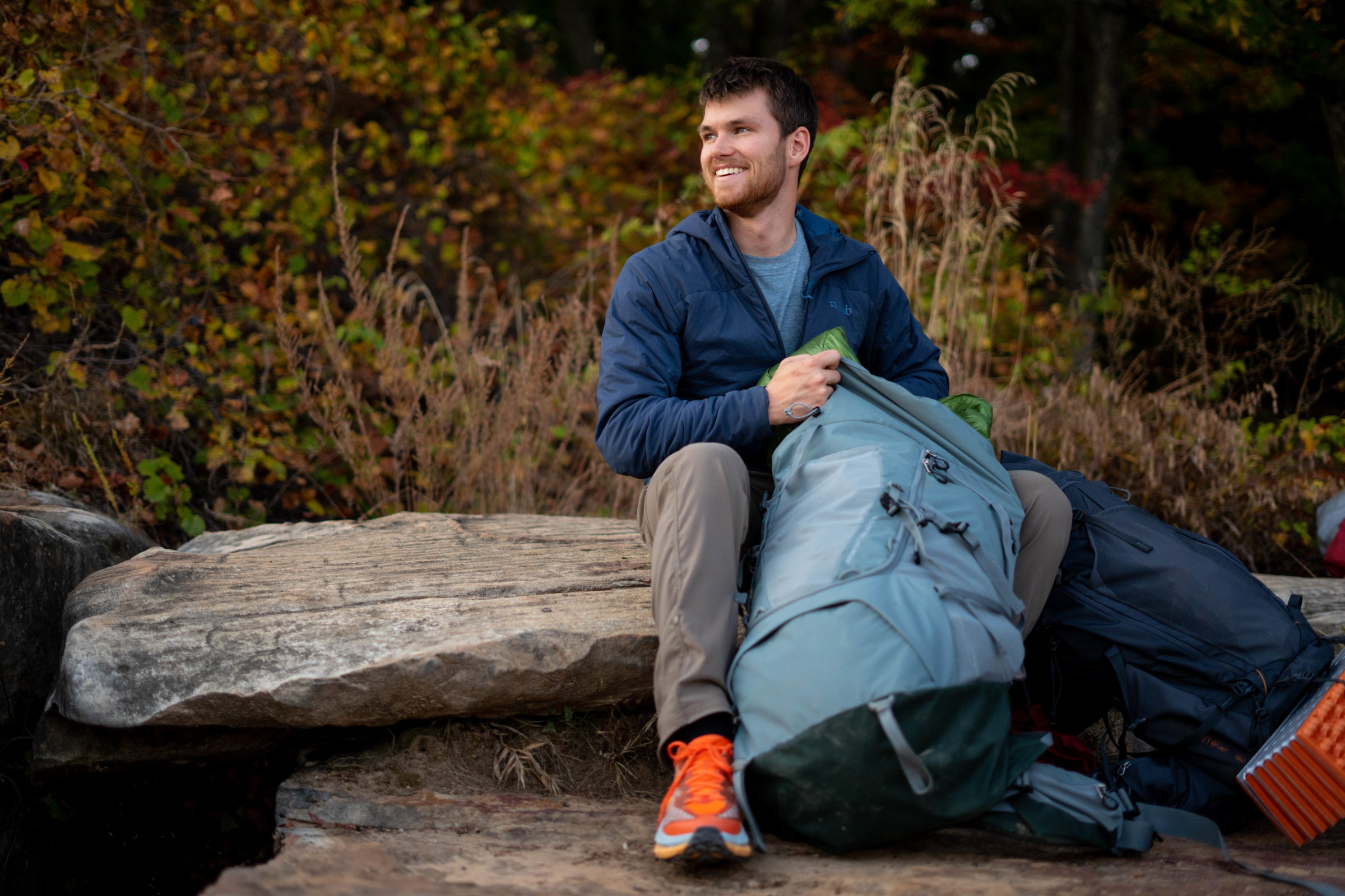 a gearjunkie tester looking through a deuter backpacking pack
