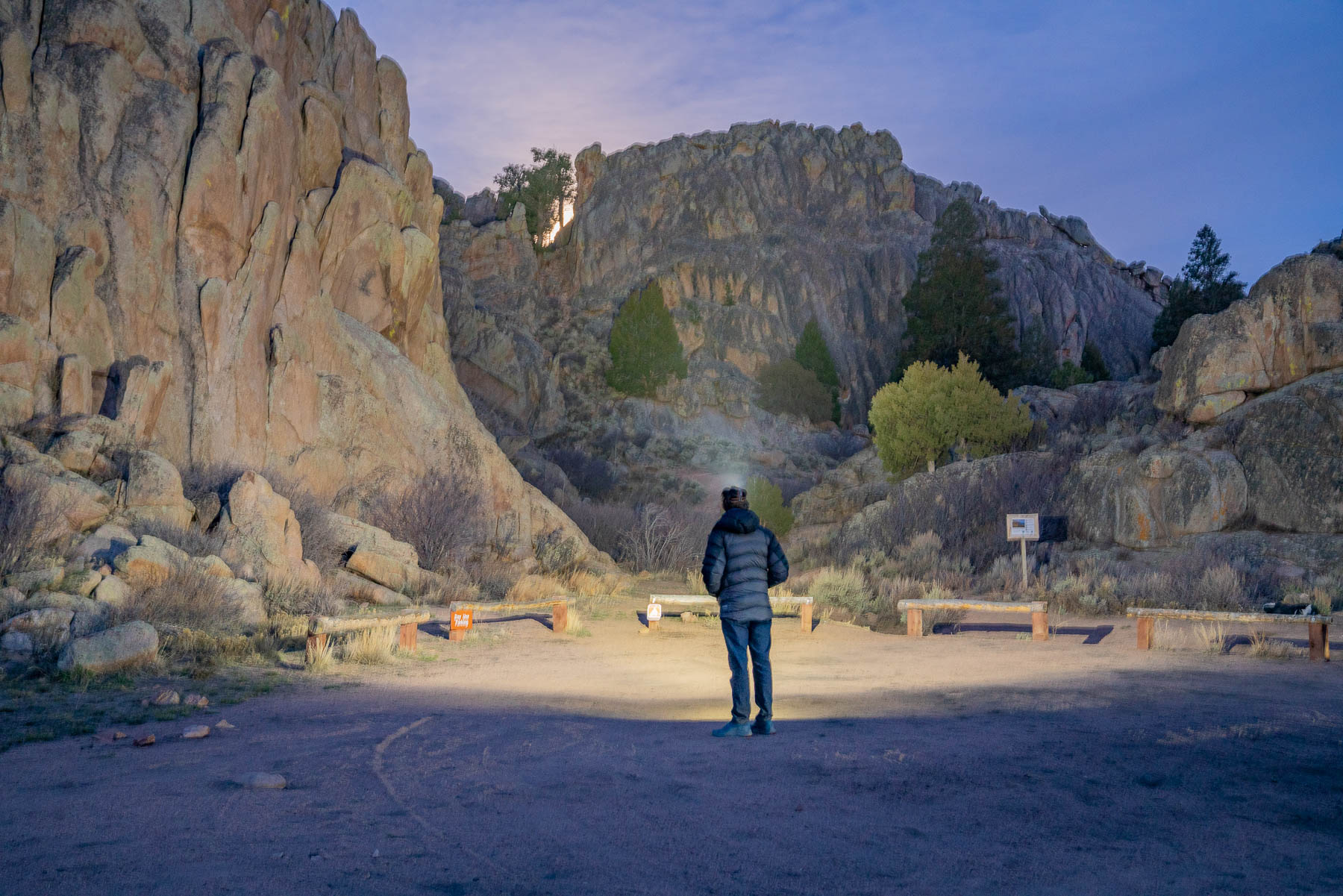 GearJunkie editor testing a headlamp among rocky outcrop