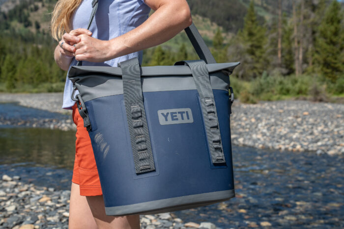 holding tote soft cooler against side 