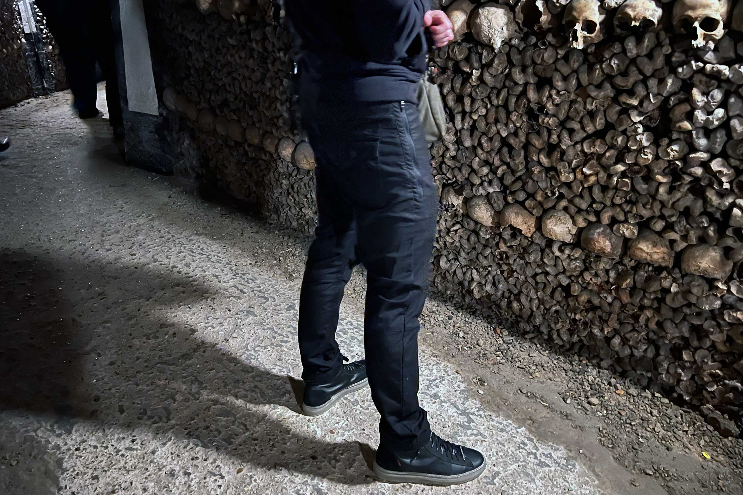 the author in the catacombs of paris wearing travel pants