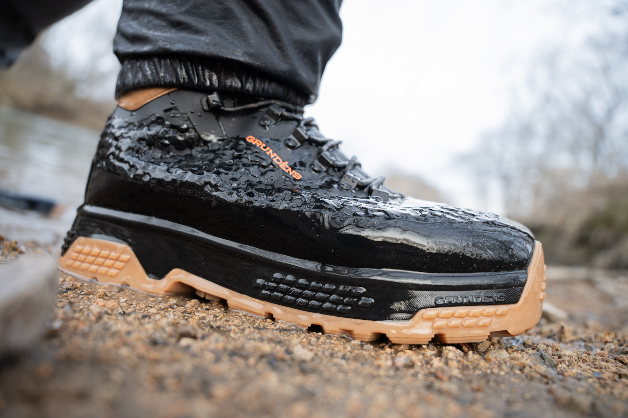A close up shot of the Grundéns Rock Armor wading boot on a riverbank.