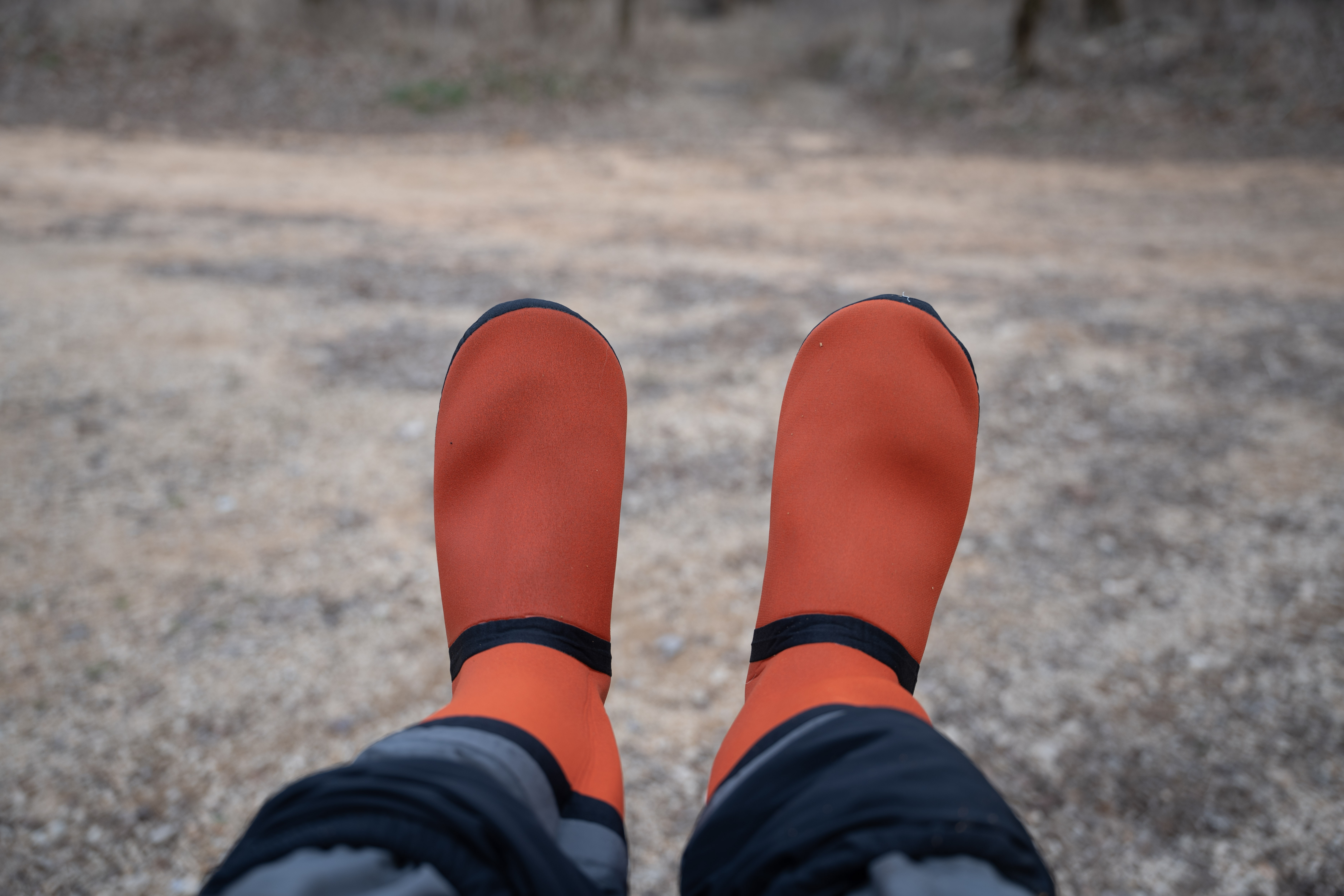 The booties on the Grundens Vector Zip waders in front of a parking lot.