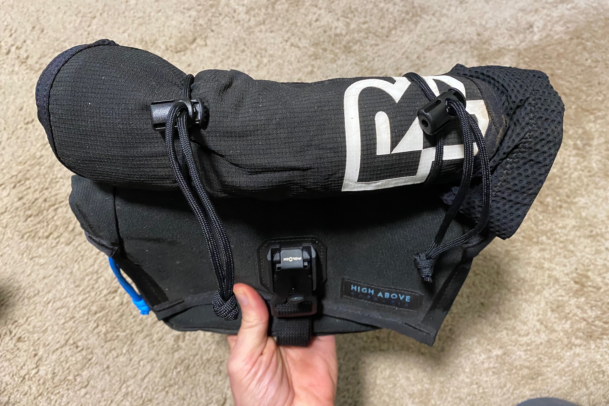 Knee pads strapped to the outside of the High Above venture Hip Pack