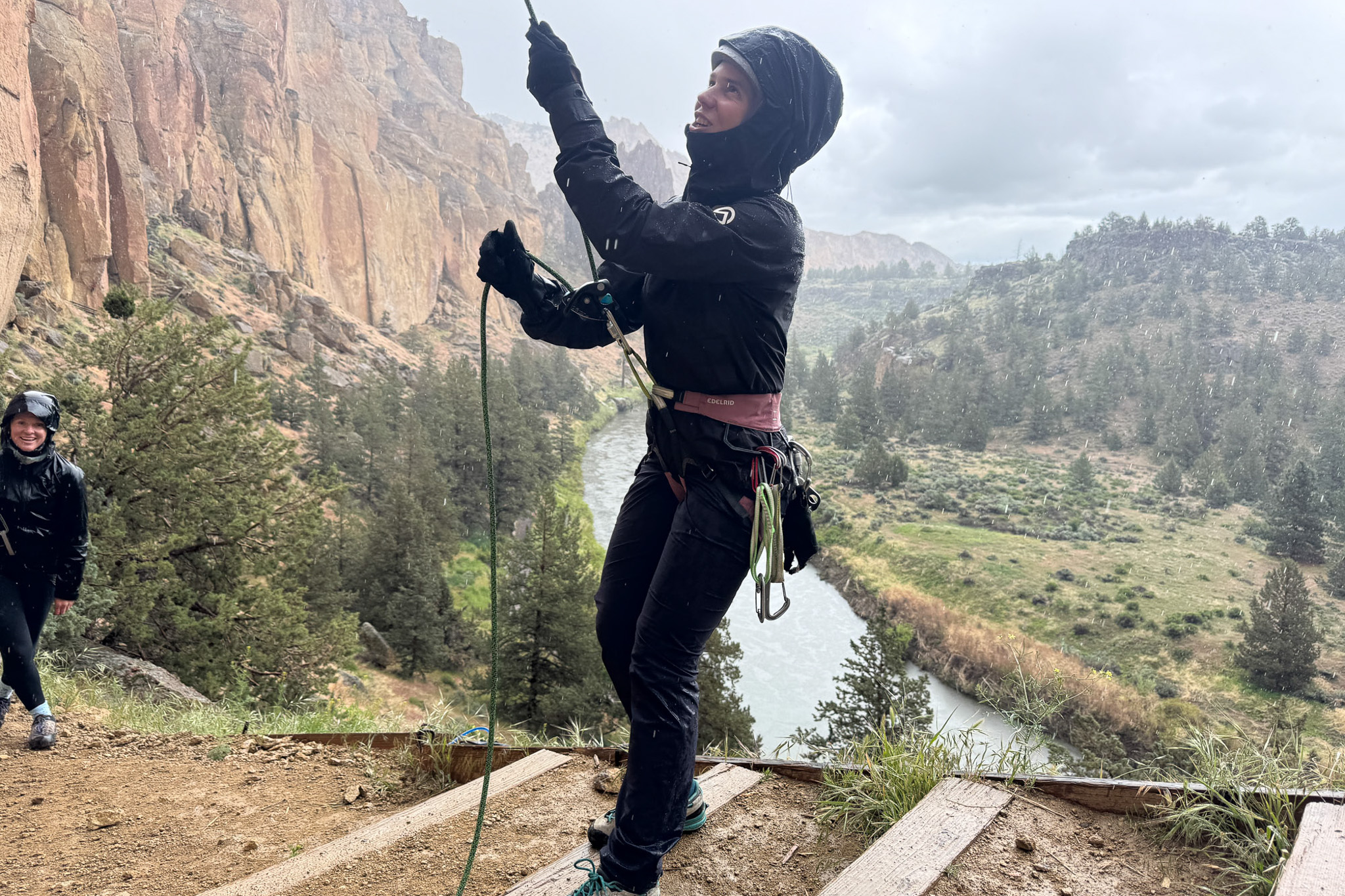 the author belays at smith rock state park while wearing the papsura jacket