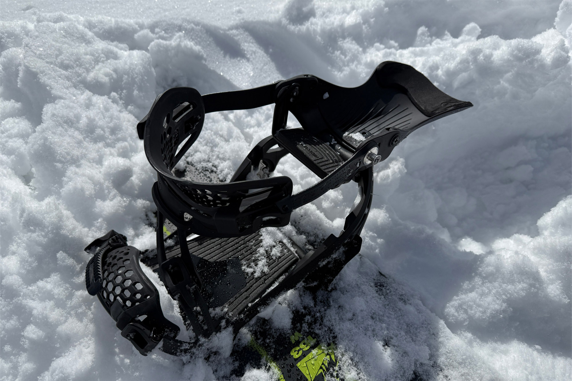 The LT binding is shown open with the highback folded down in soft snow