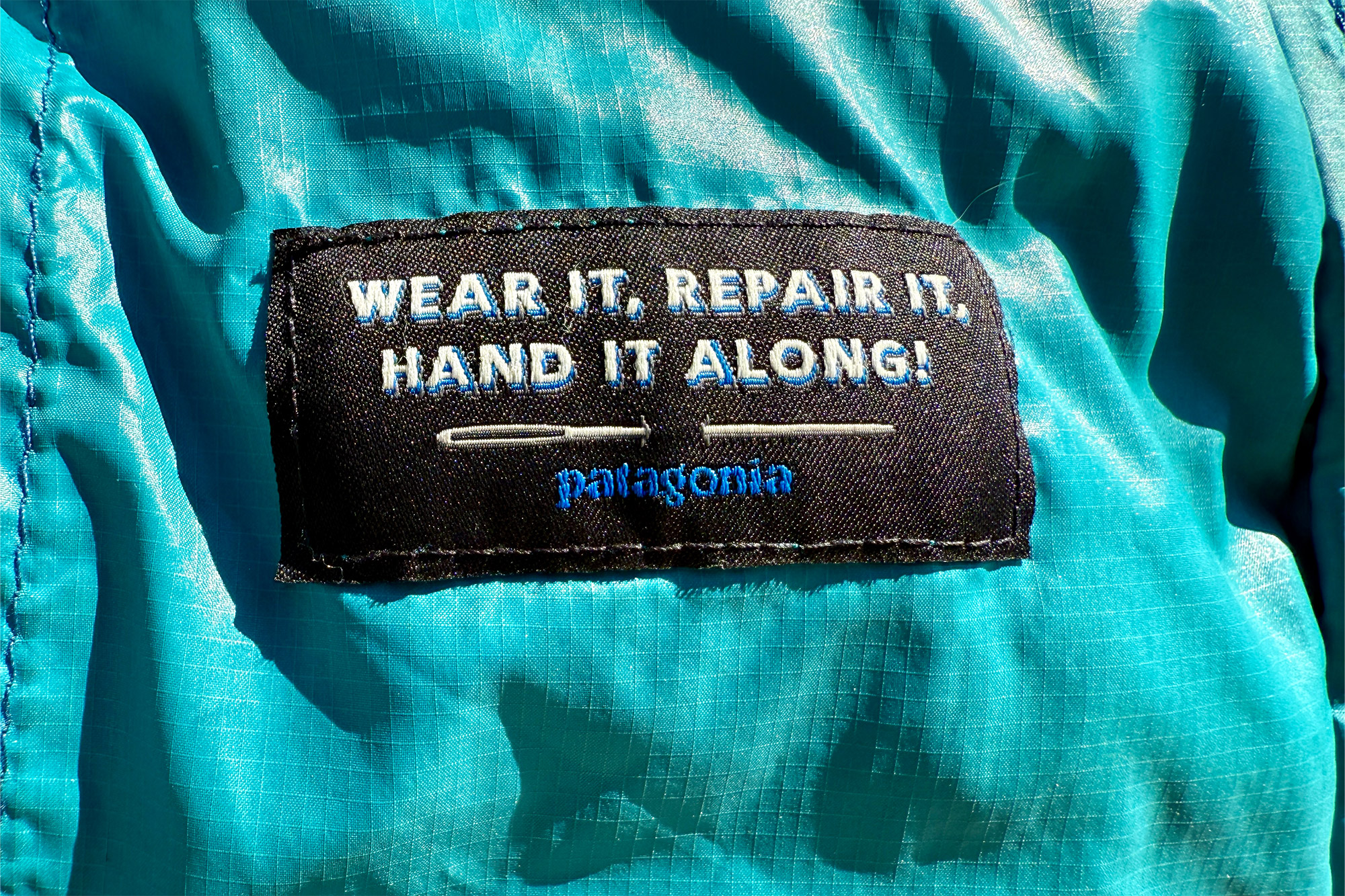 Patagonia Down Sweater Hoody repair and reuse label close-up