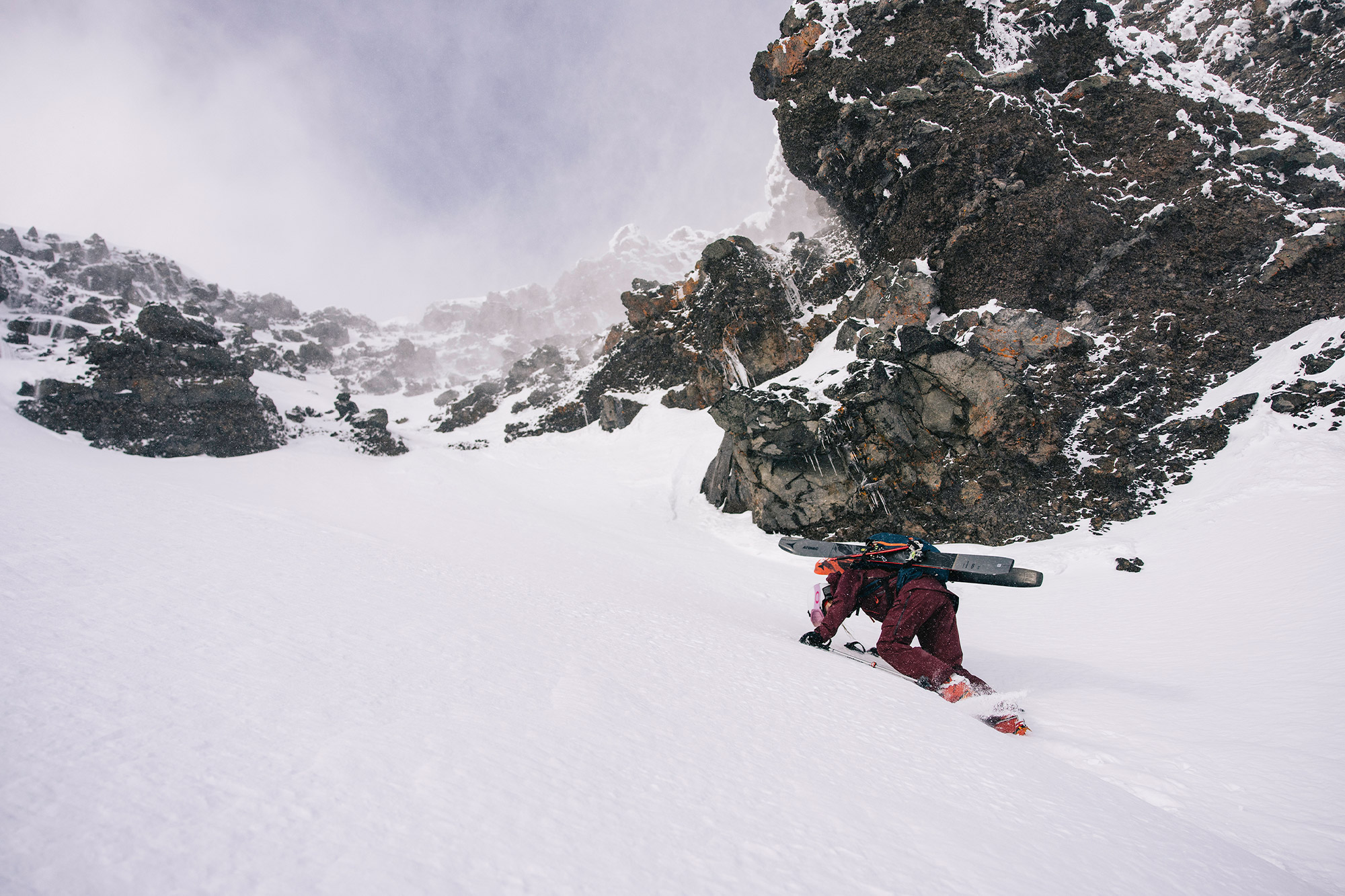 Ski mountaineer climbing icy terrain with technical gear