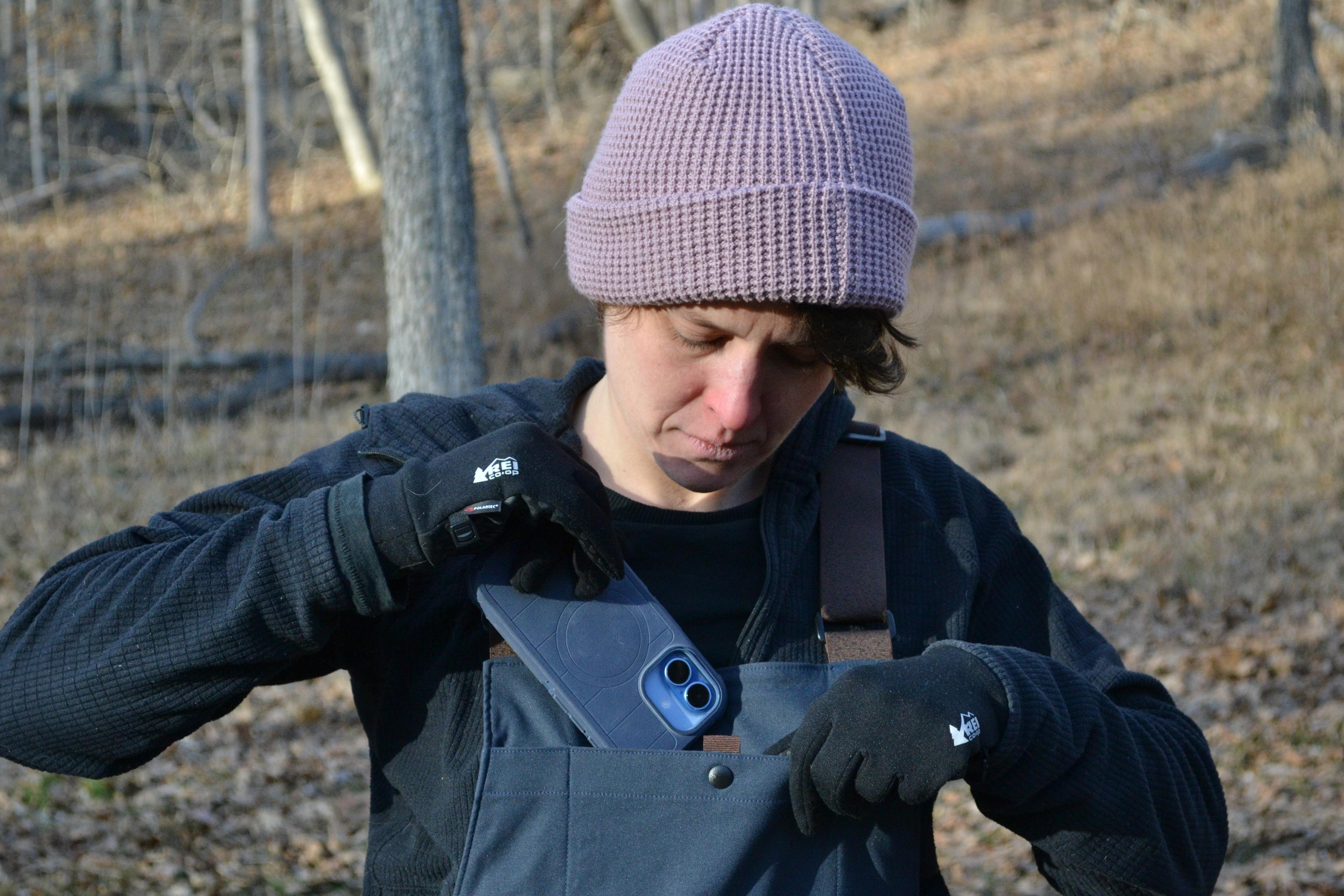 person puts phone in pocket