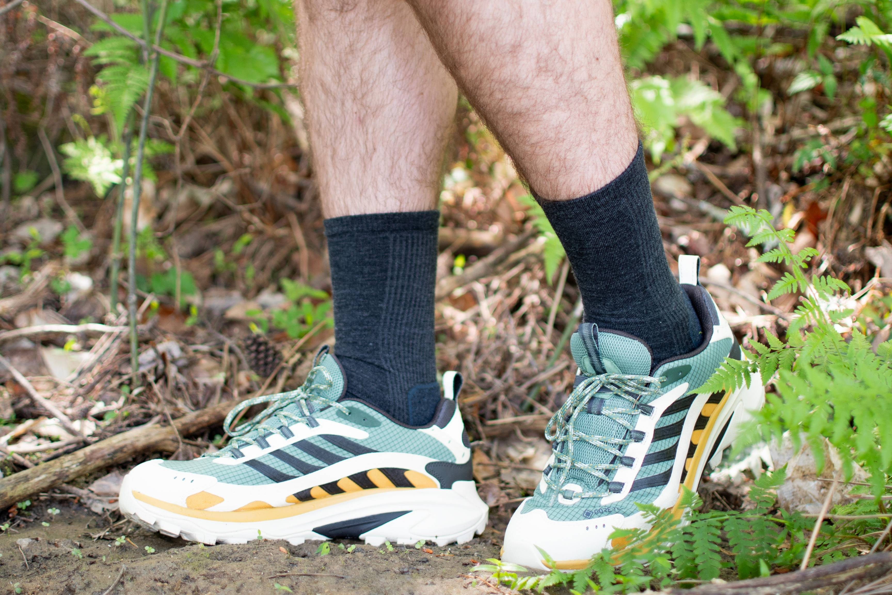 close up shot of hiker wearing hiking shoes and socks