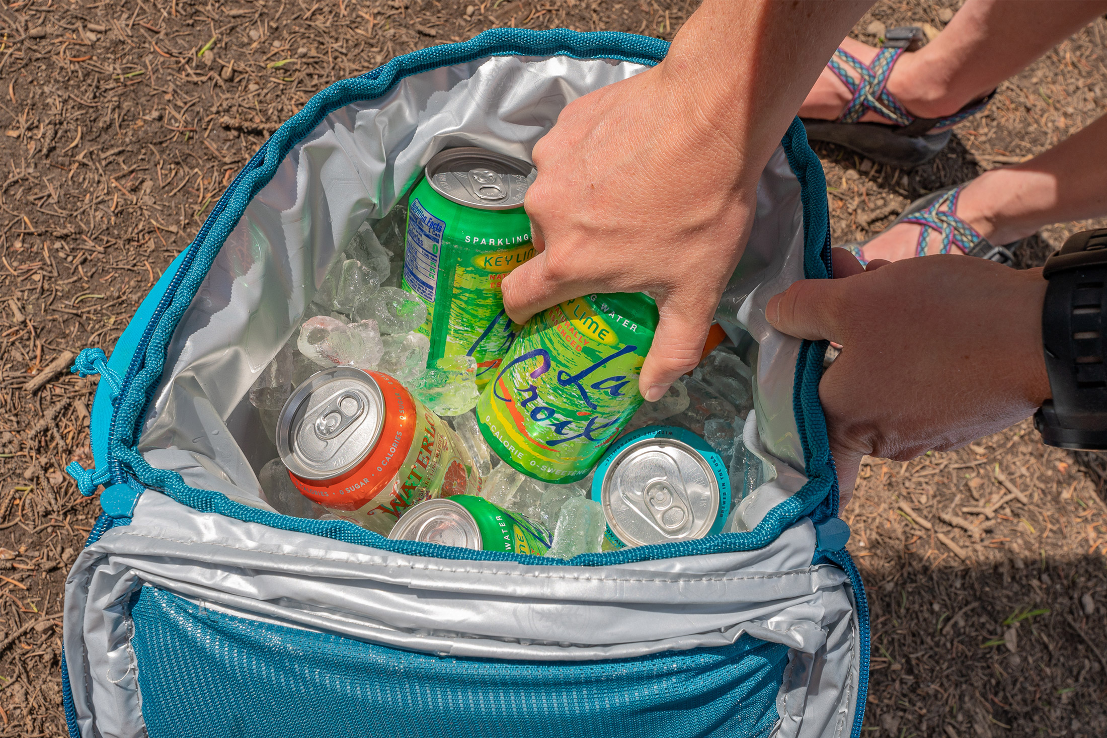 cans in a backpack cooler with ice