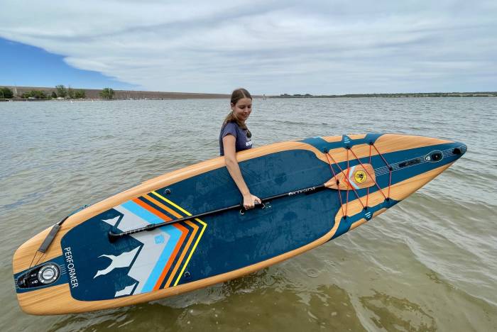 carrying the body glove SUP into a lake