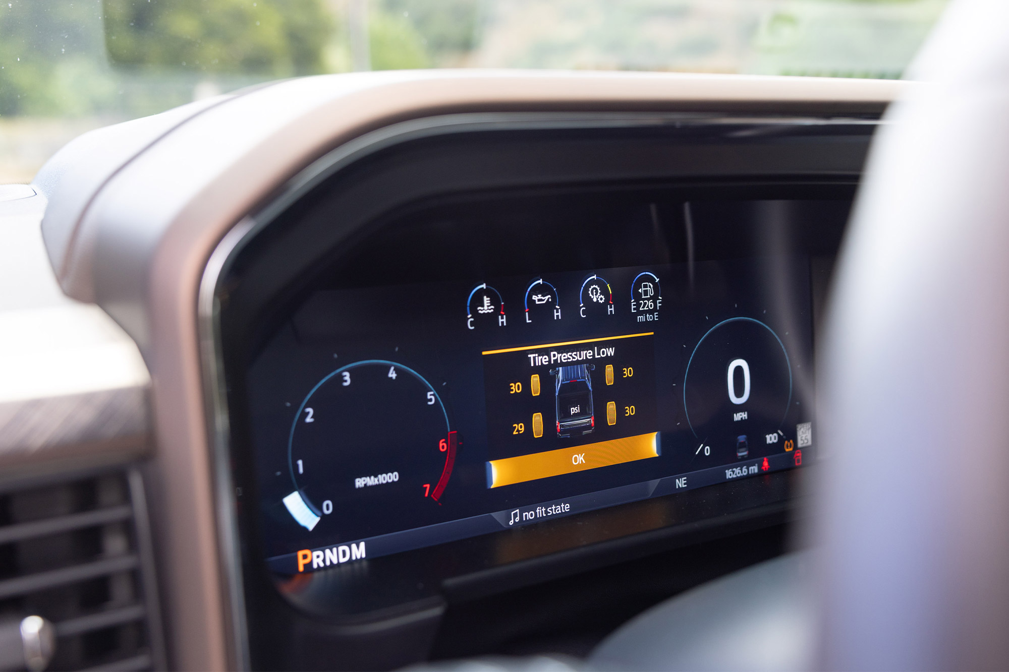 Digital gauge cluster showing tire pressure warning in the Ford F 350 King Ranch Tremor