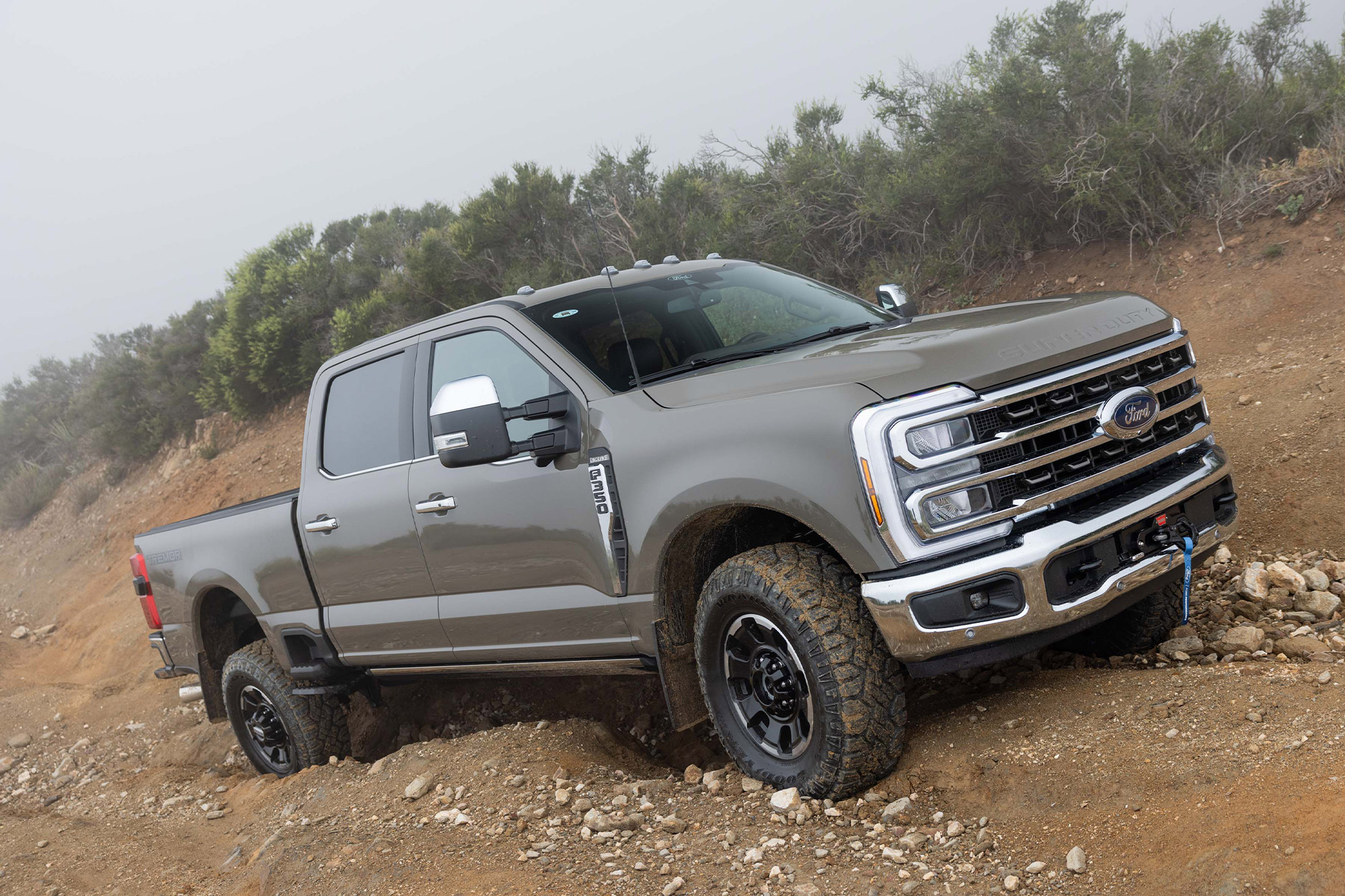 2026 Ford F 350 Tremor driving over uneven rocky terrain with visible suspension flex