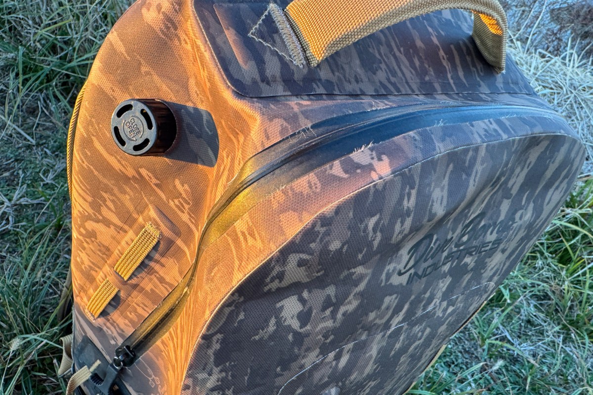 Close-up of the Divebomb Waterproof Zip Backpack showing the sealed zipper, air valve, and top carry handle