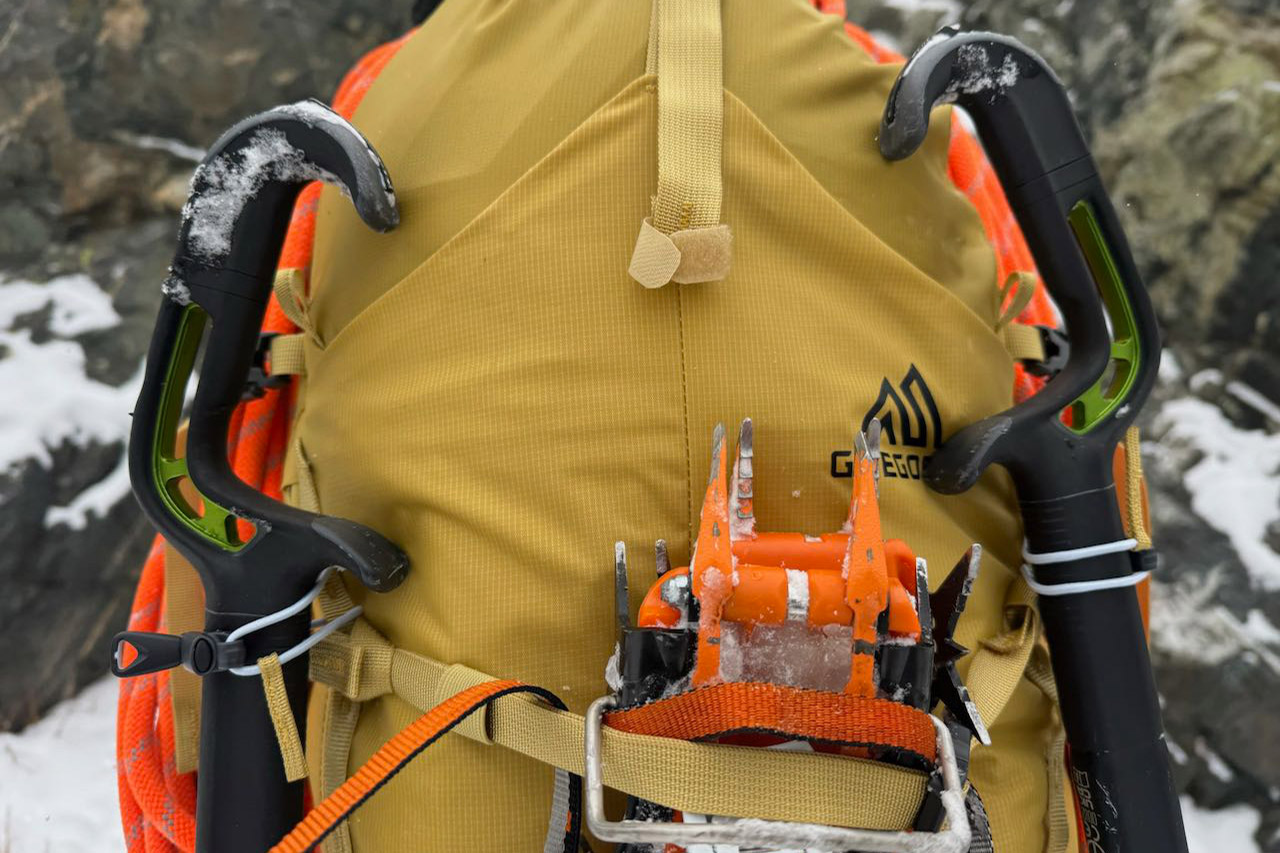 Close view of ice tools and crampons attached to the Gregory Alpinisto 30 backpack