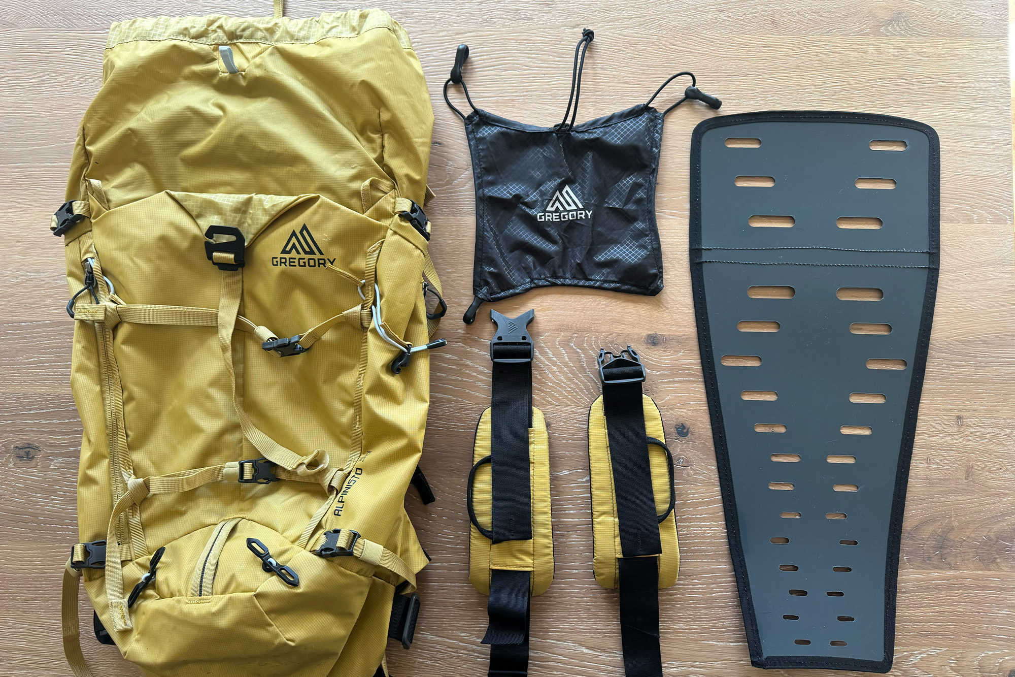 Gregory Alpinisto 30 backpack with removable parts and accessories laid out