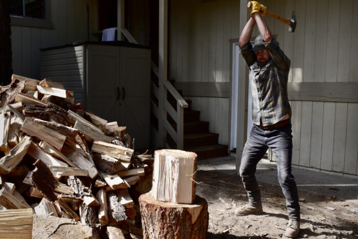 a man splitting wood with an axe