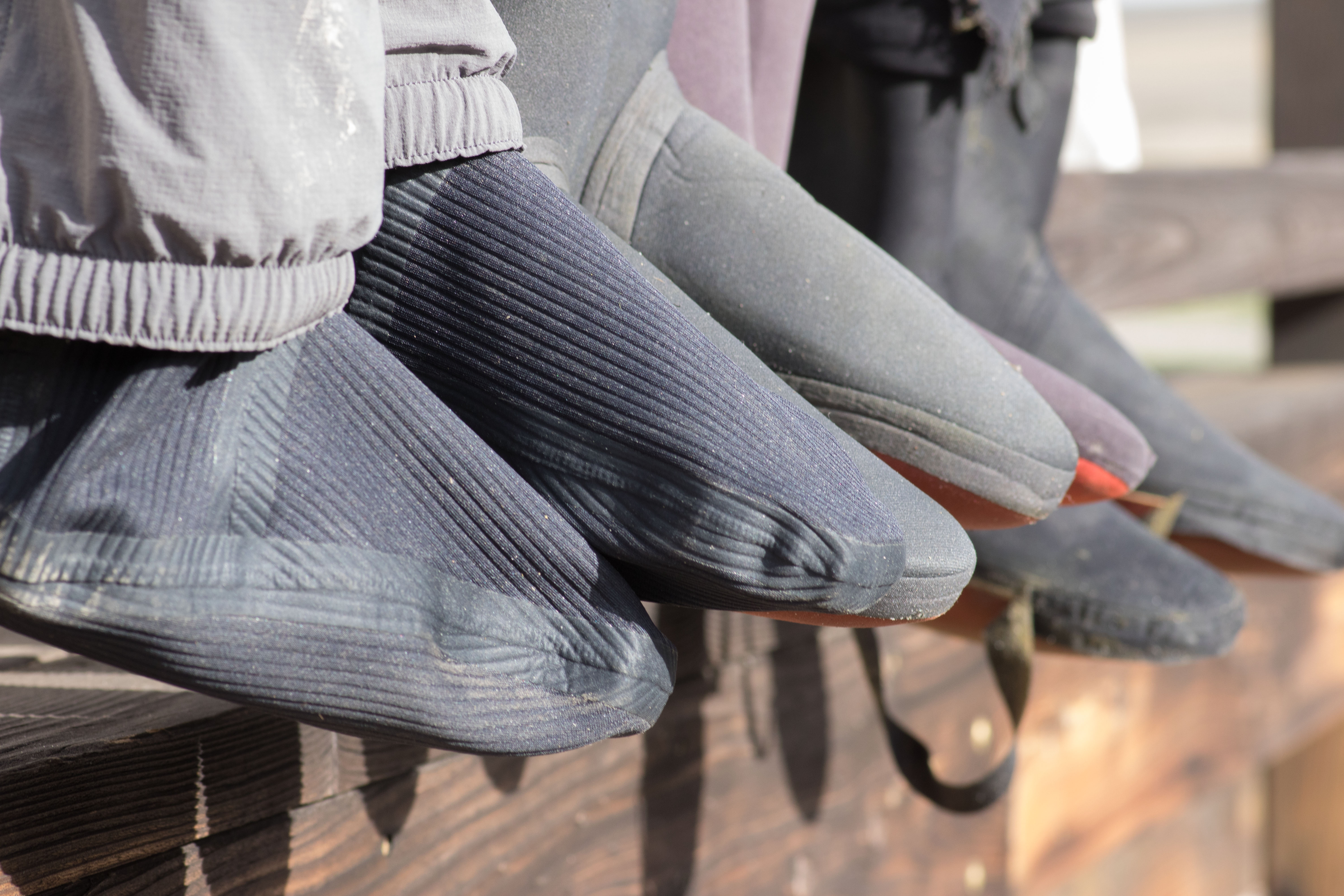 The booties of the Simms Flyweight wader lined up with other waders