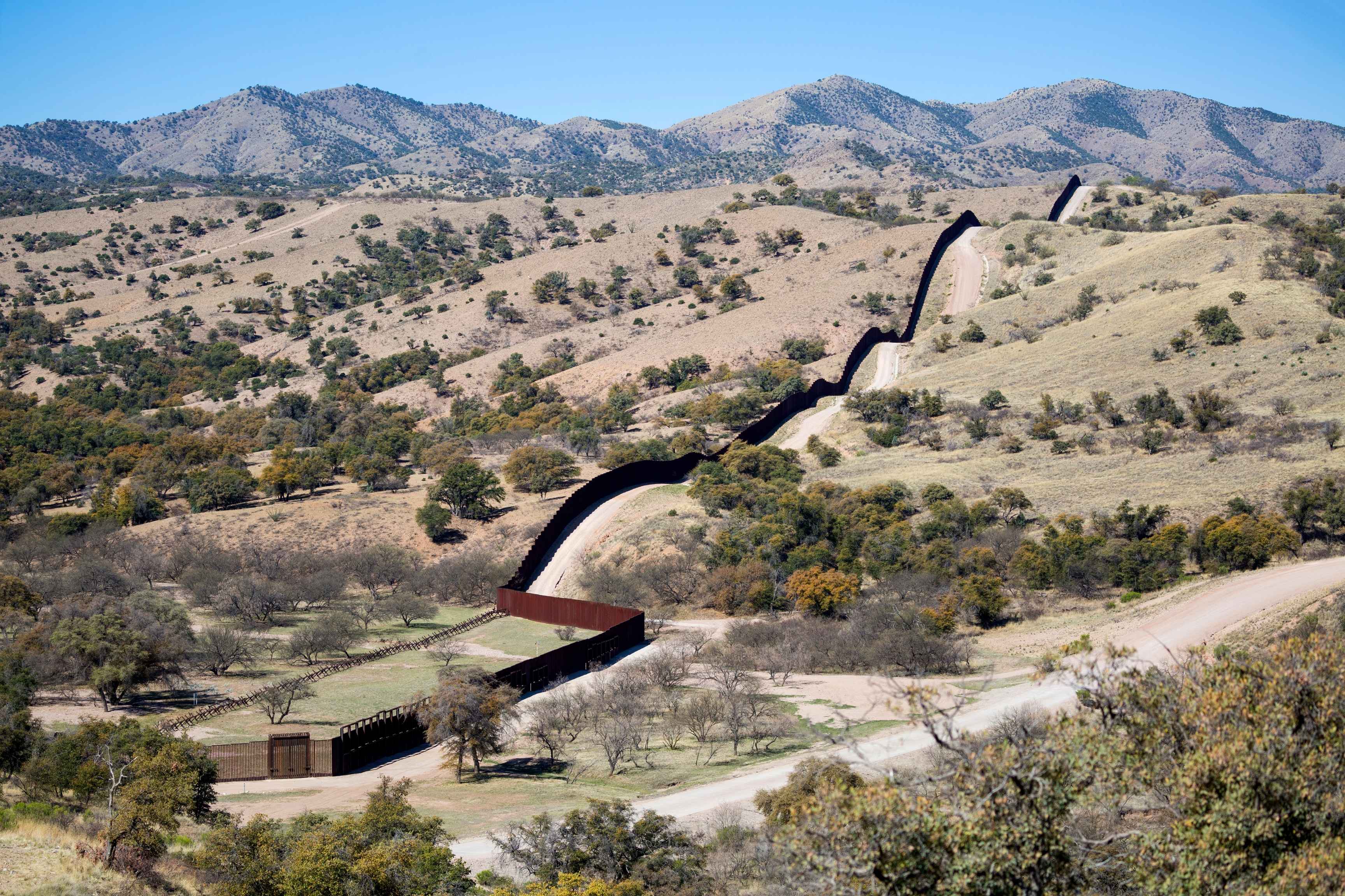 border wall through a mountainous countryside