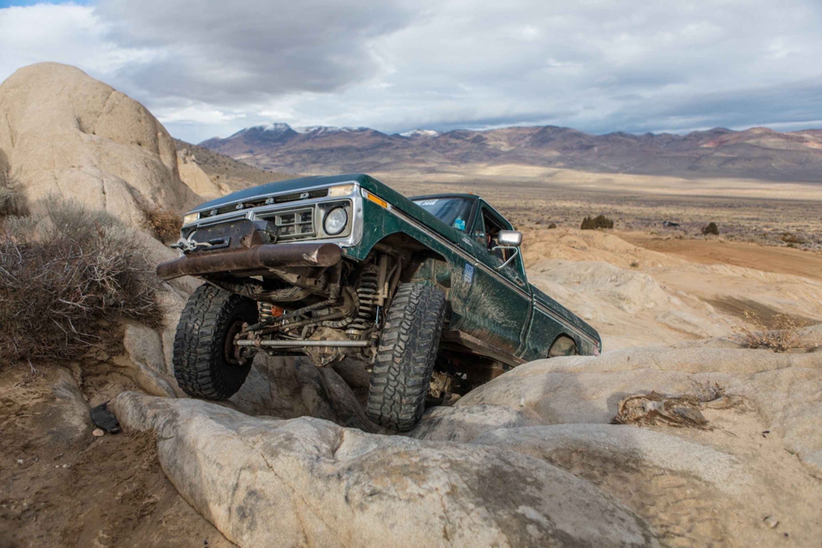Ford Bronco off roading goes up on rock 