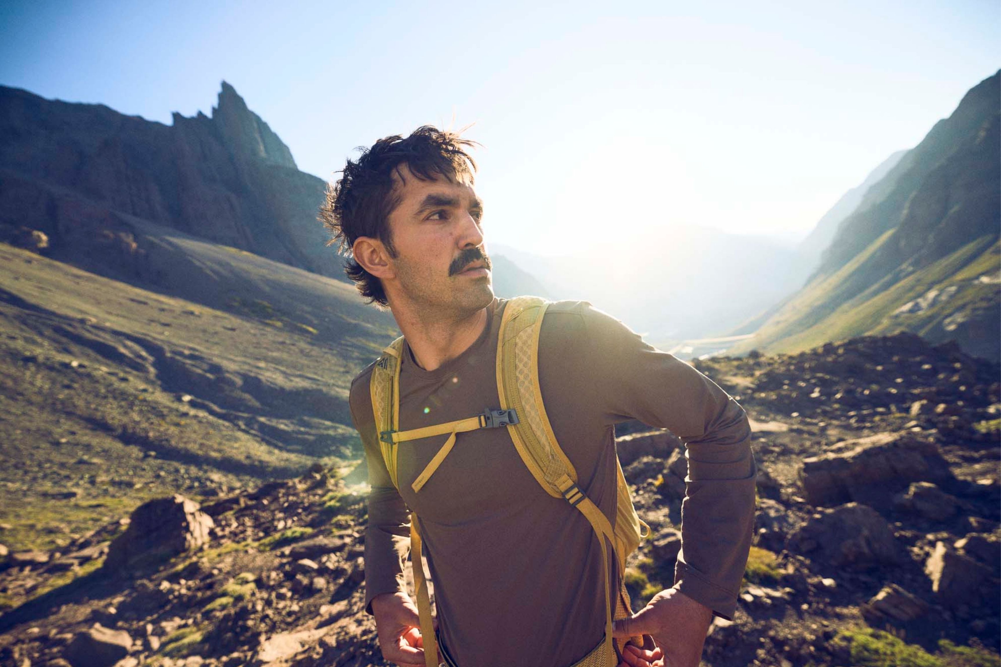 close up shot of person wearing daypack in the mountains