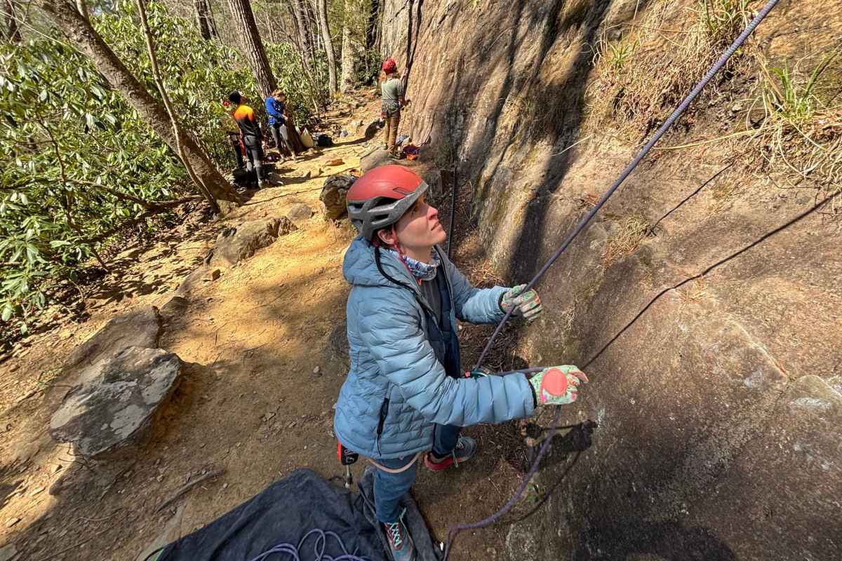 belayer wearing blue down jacket